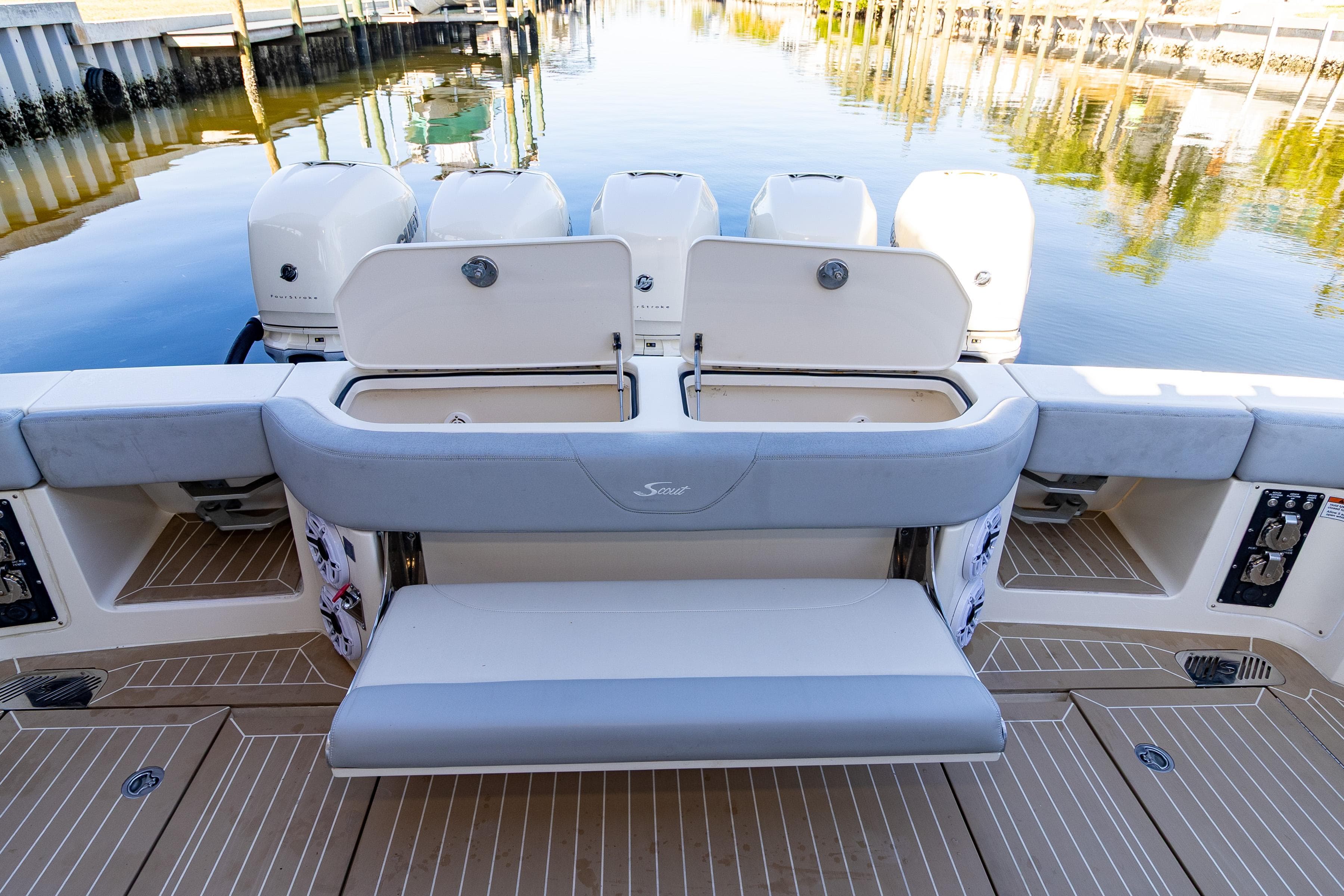 2020 Scout 530LXF boat with open storage compartments and seating at the stern.