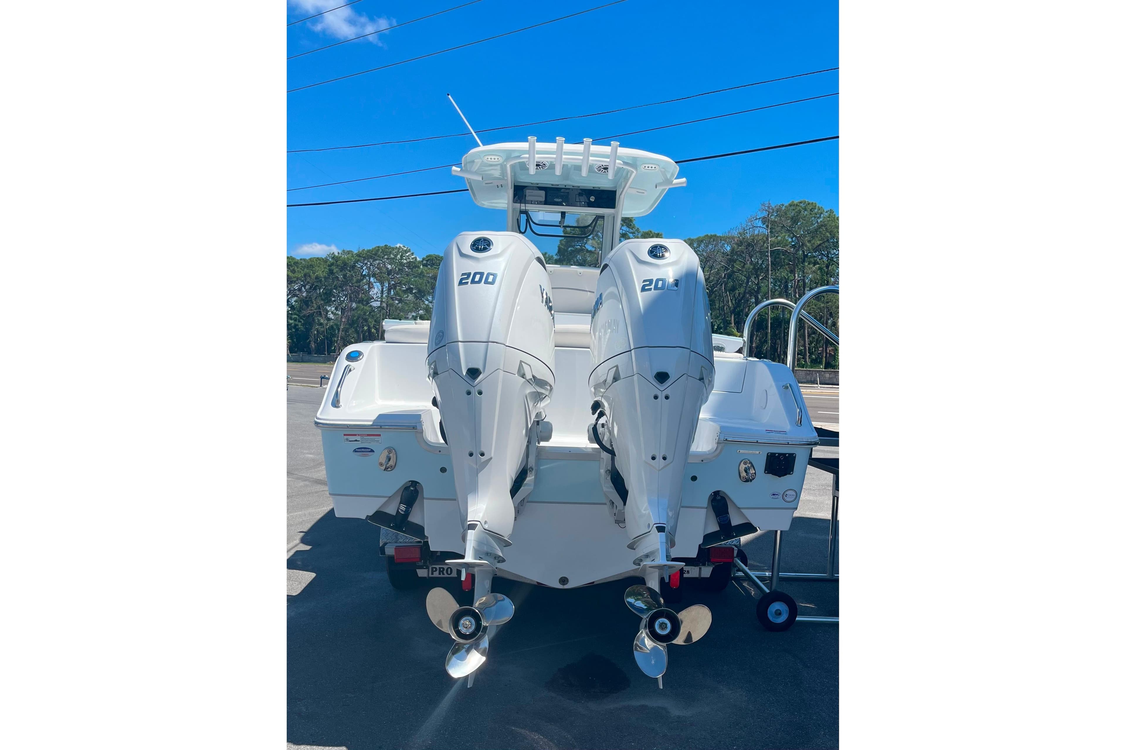 2026 Sea Hunt Ultra 265 SE boat with dual 200 horsepower engines, parked outdoors.