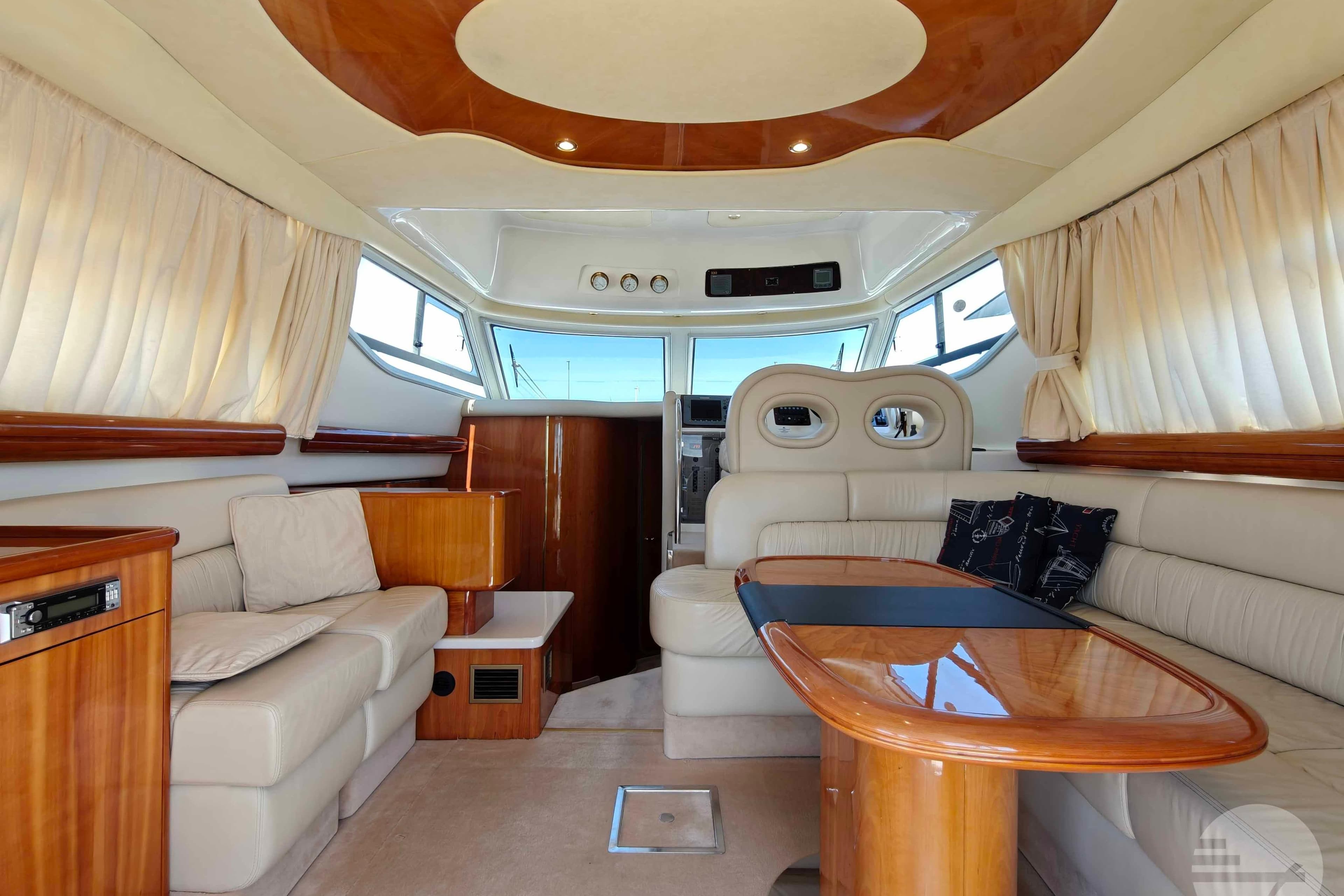 Luxurious interior of 2007 Cranchi Atlantique 40 yacht with elegant wood and leather furnishings.