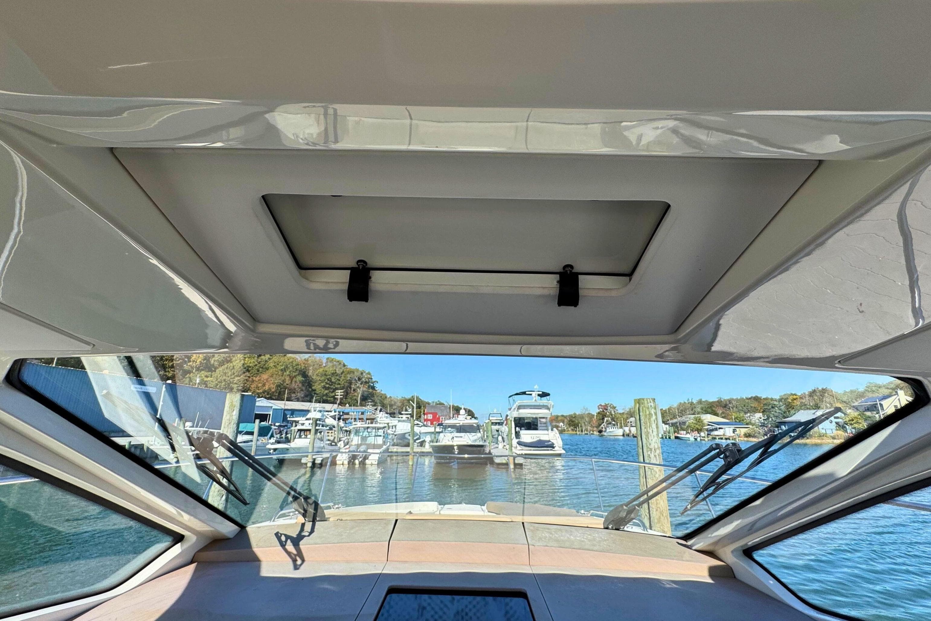 Interior view from 2017 Sea Ray Sundancer 350 Coupe, overlooking marina with boats.