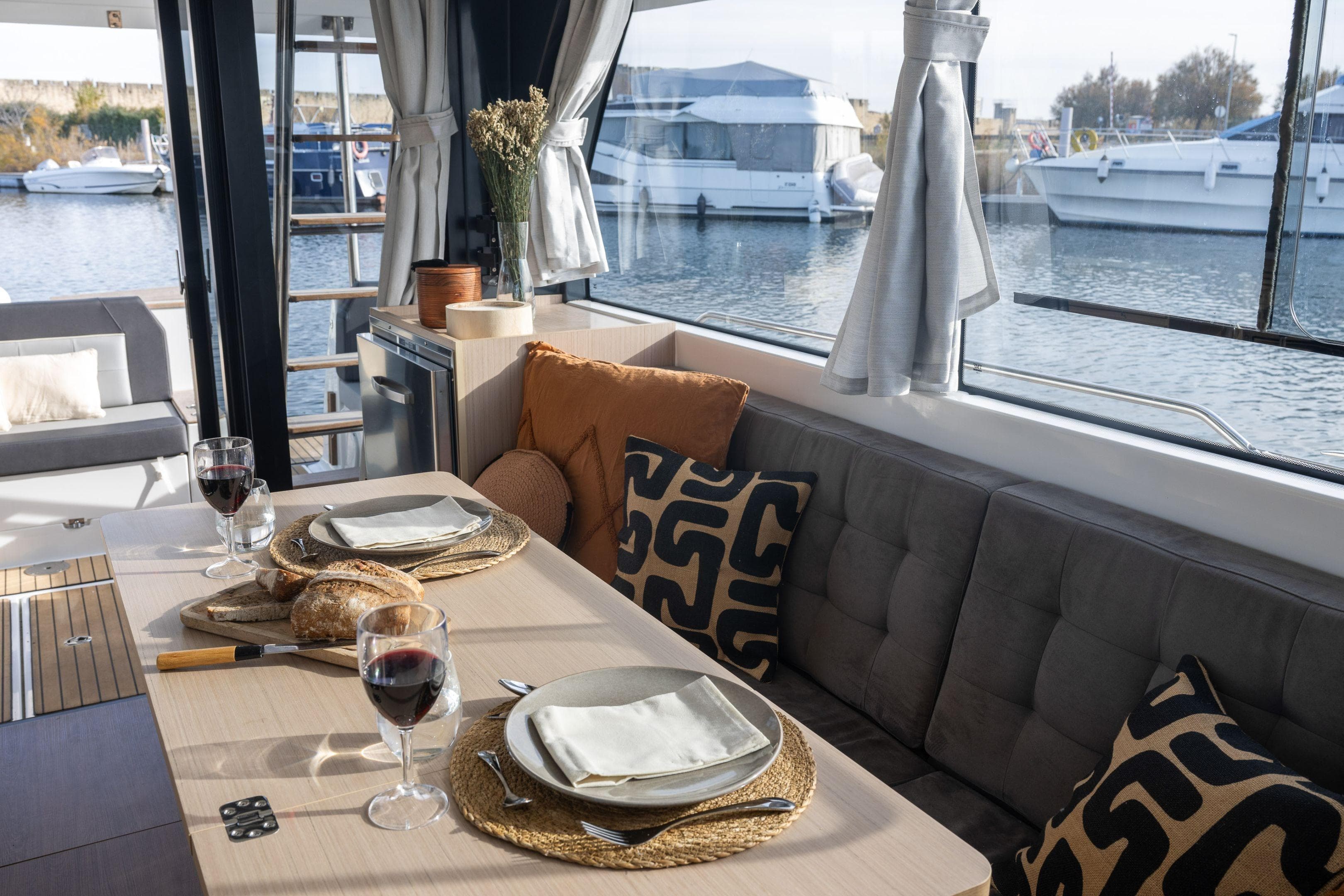 Luxurious interior of 2026 Delphia D12 Fly yacht with elegant dining setup.