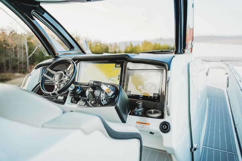 Cockpit of 2018 MTI 57 boat with advanced navigation system and steering wheel.