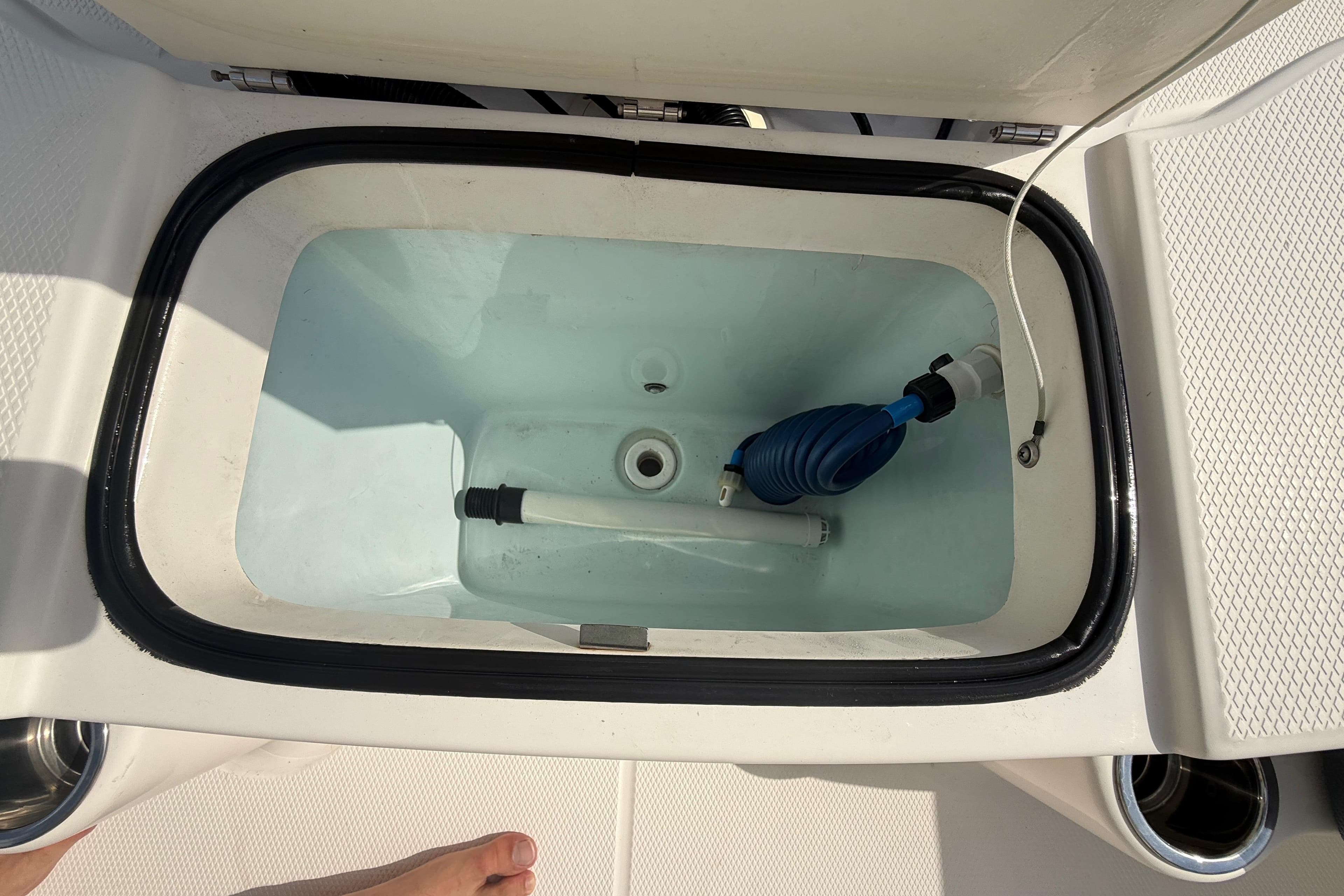 Livewell on 2021 Robalo R180 Center Console boat, featuring a clean interior and hose attachment.