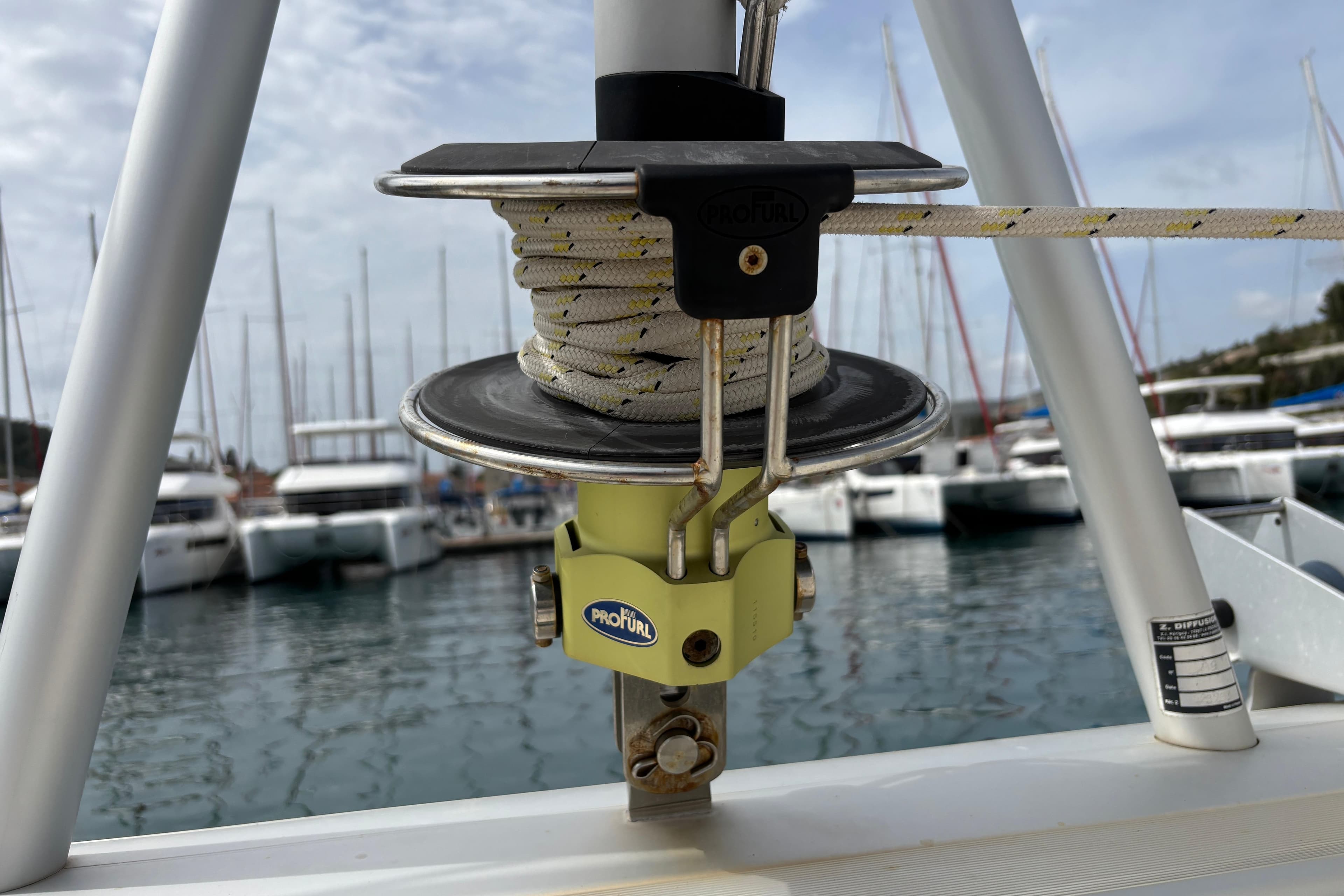Close-up of a ProFurl system on a 2020 Leopard 45 catamaran in a marina.