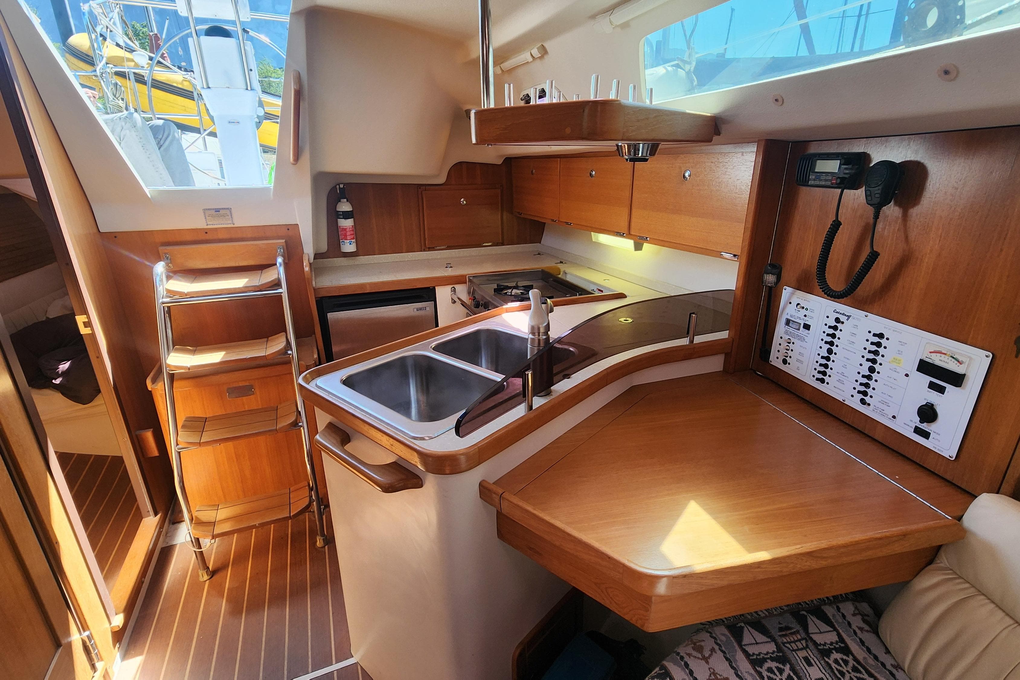 Interior of 2007 Catalina 320 MkII sailboat with kitchen and navigation panel.