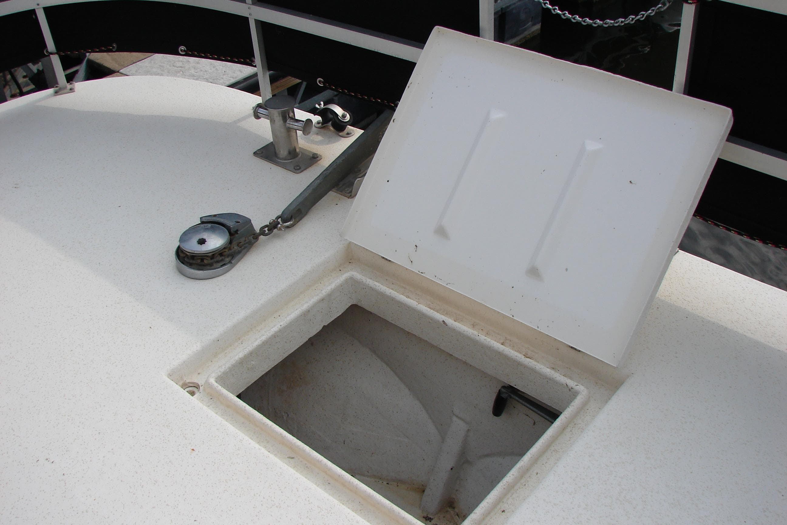 Open hatch on 1997 Gibson 47 Sport Houseboat deck, showing storage compartment.