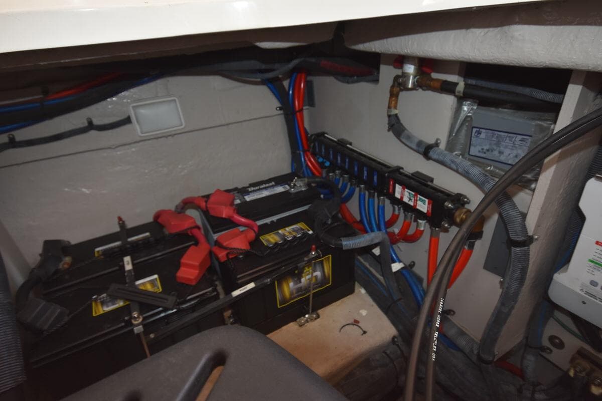 Electrical system of a 2003 Sea Ray 360 Sundancer boat, featuring batteries and wiring.