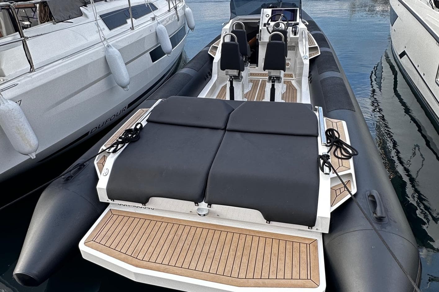 2022 Fugu 29 boat with sleek design, docked between yachts.