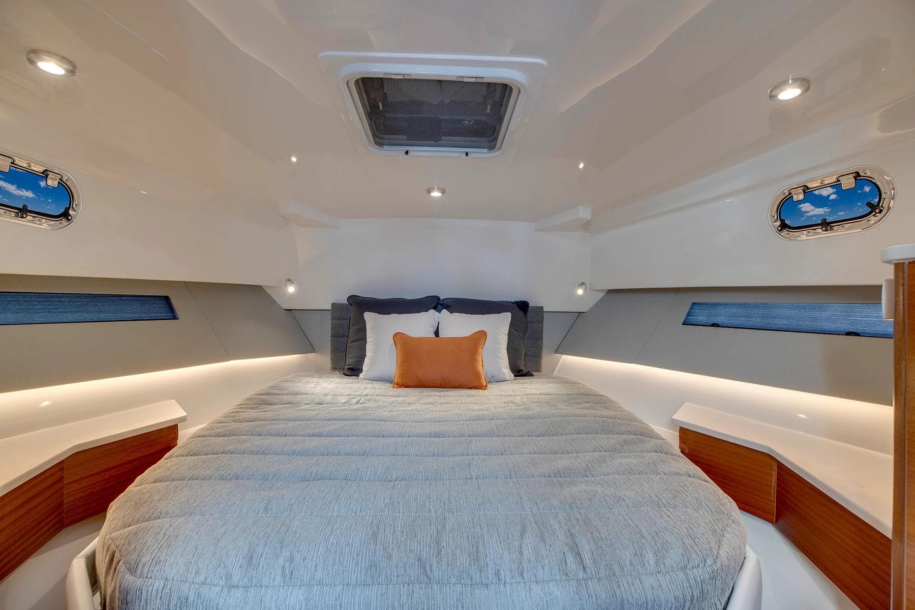 Manufacturer Provided Image: Luxurious cabin interior of 2025 Pursuit OS 445 Offshore yacht with cozy bedding.