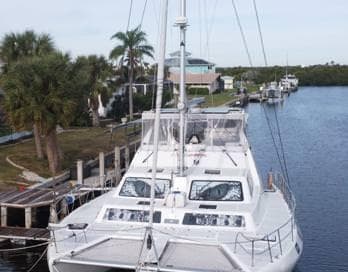 2017 Royal Cape Catamarans Majestic 53 docked in a scenic canal setting.