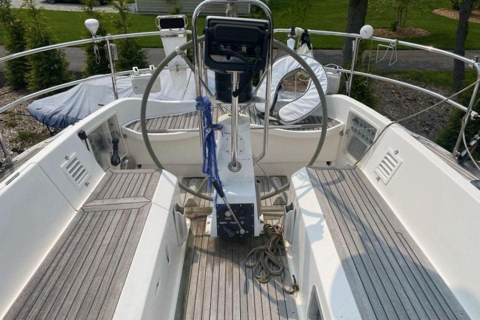 Cockpit of 1992 Nautor Swan 44 sailboat with dual steering wheels and wooden deck.