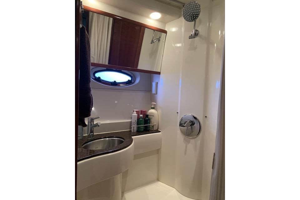 Luxurious bathroom in 2009 Meridian 391 Sedan yacht with modern fixtures.