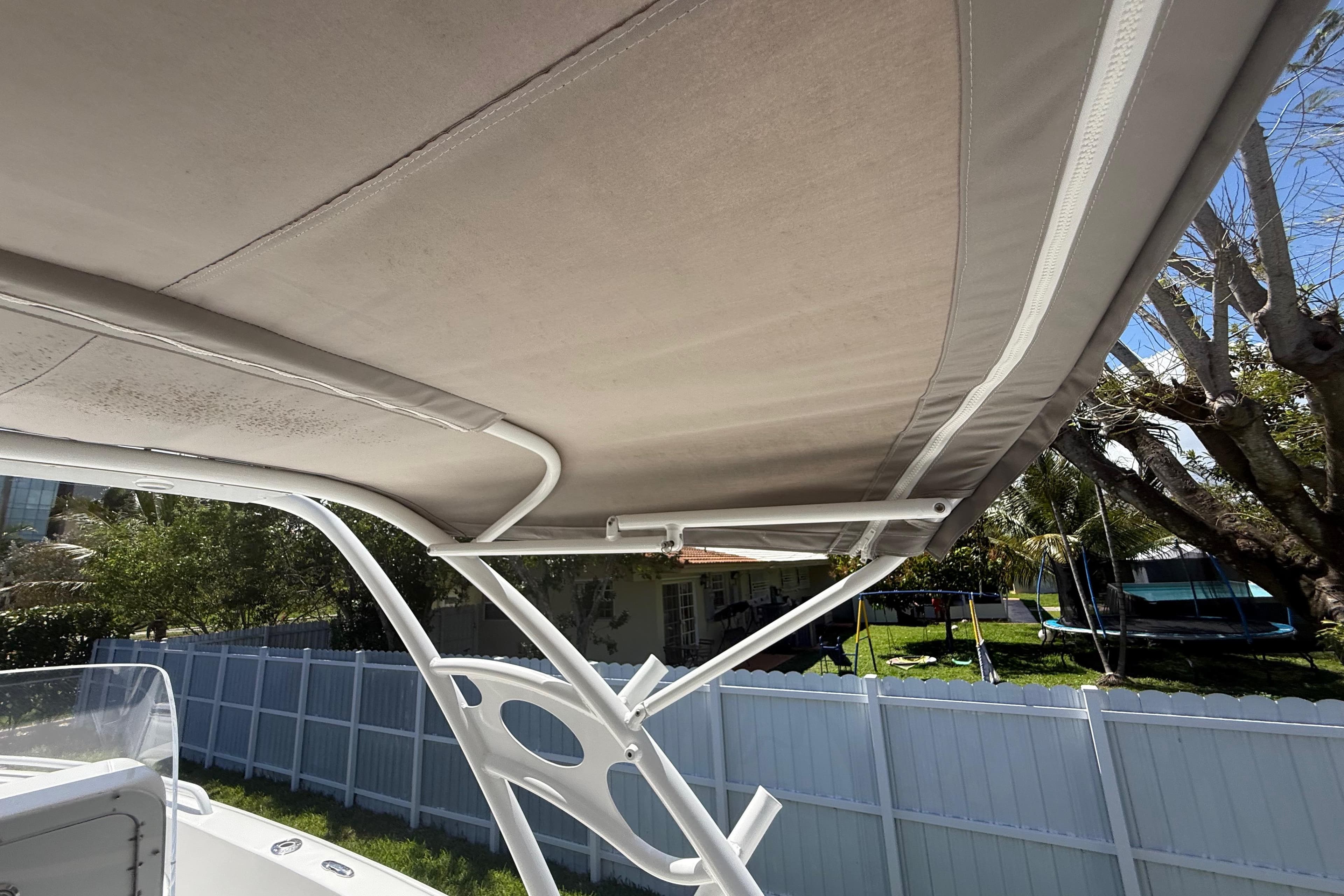 2015 Concept 27 boat canopy with white frame, outdoor setting.