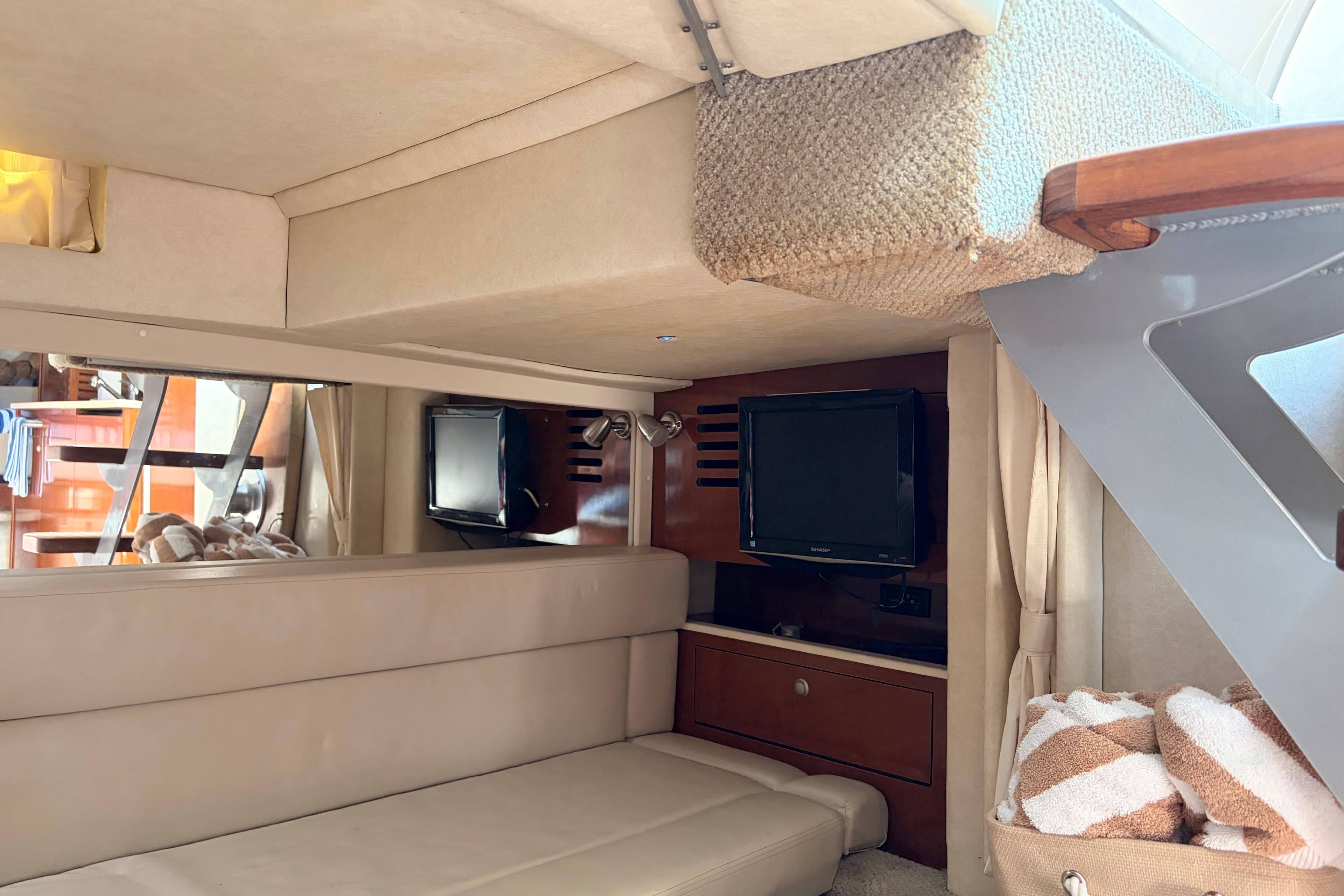 Interior of 2008 Sea Ray Sundancer 350 yacht with cozy seating and TV.