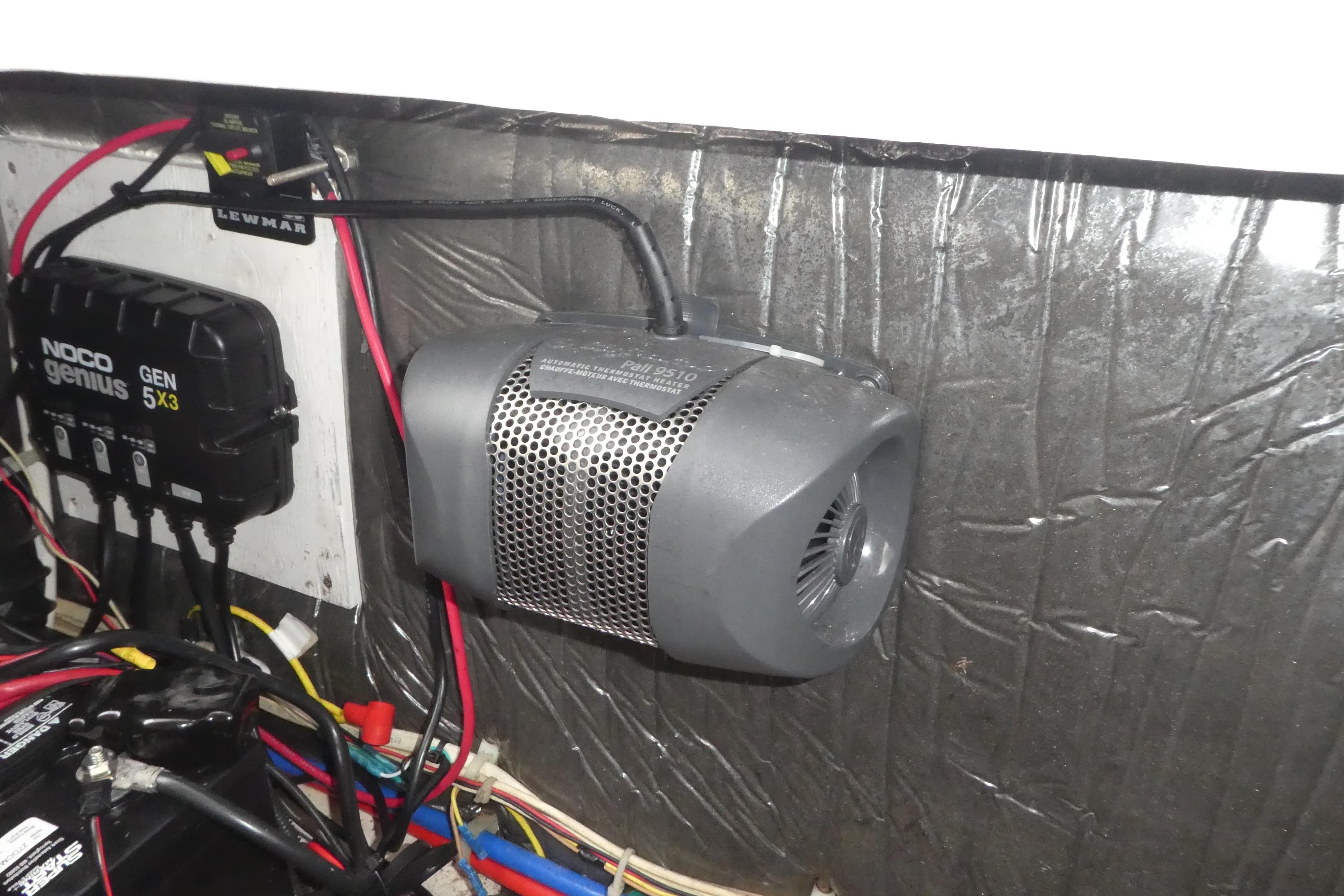 Electrical components inside a 2002 Bayliner 2855 Ciera boat, featuring a NOCO Genius charger.