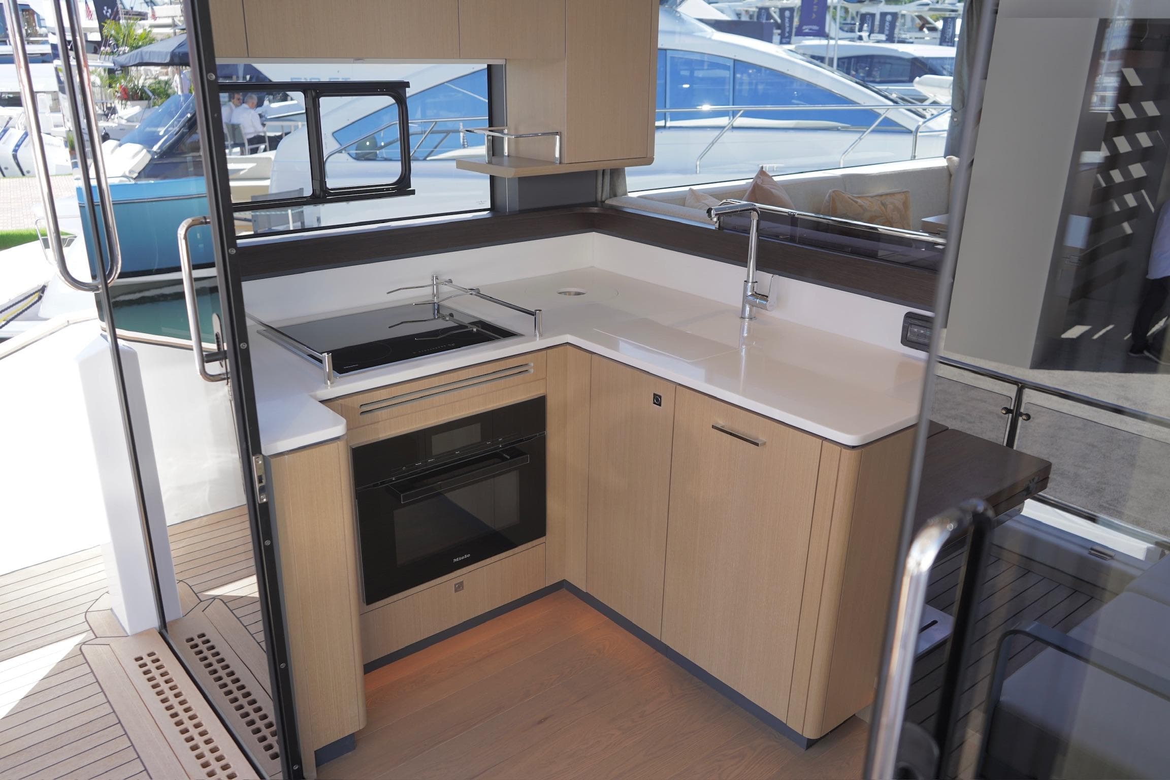 Modern kitchen interior on 2025 Sirena 48 Coupe yacht, featuring sleek cabinetry and appliances.