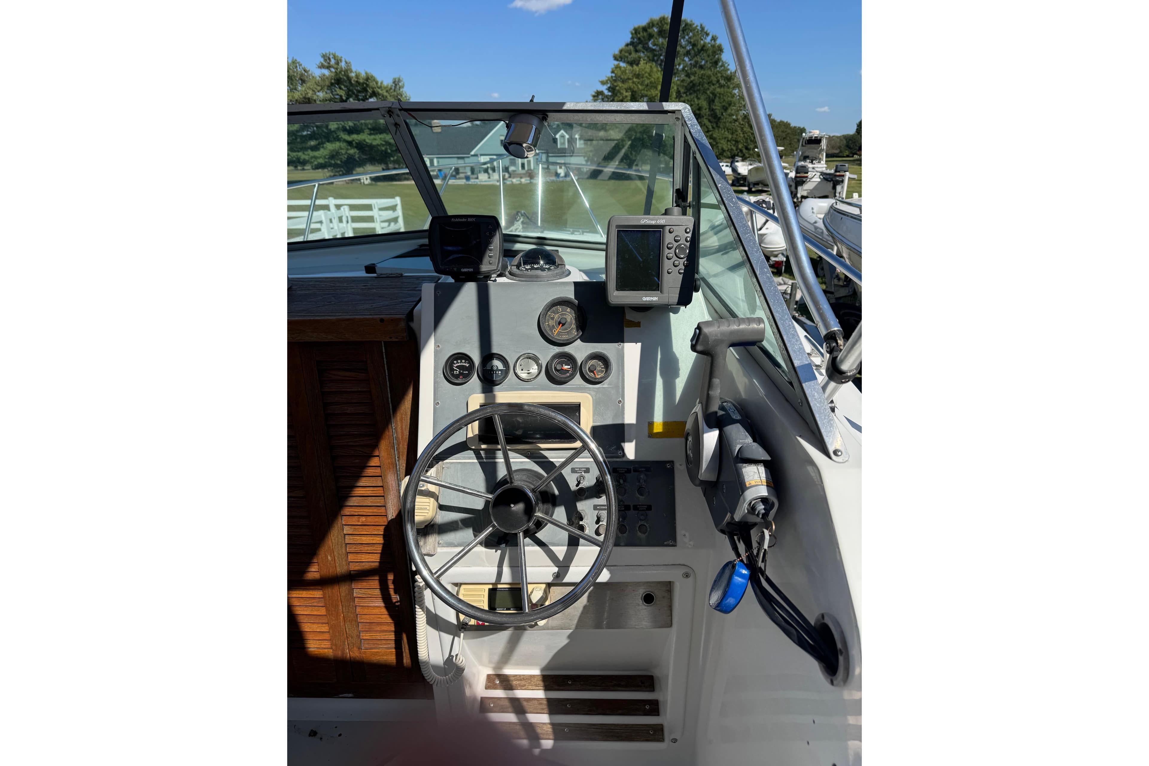 1988 Chris-Craft 215 Sea Hawk boat dashboard with steering wheel and navigation instruments.