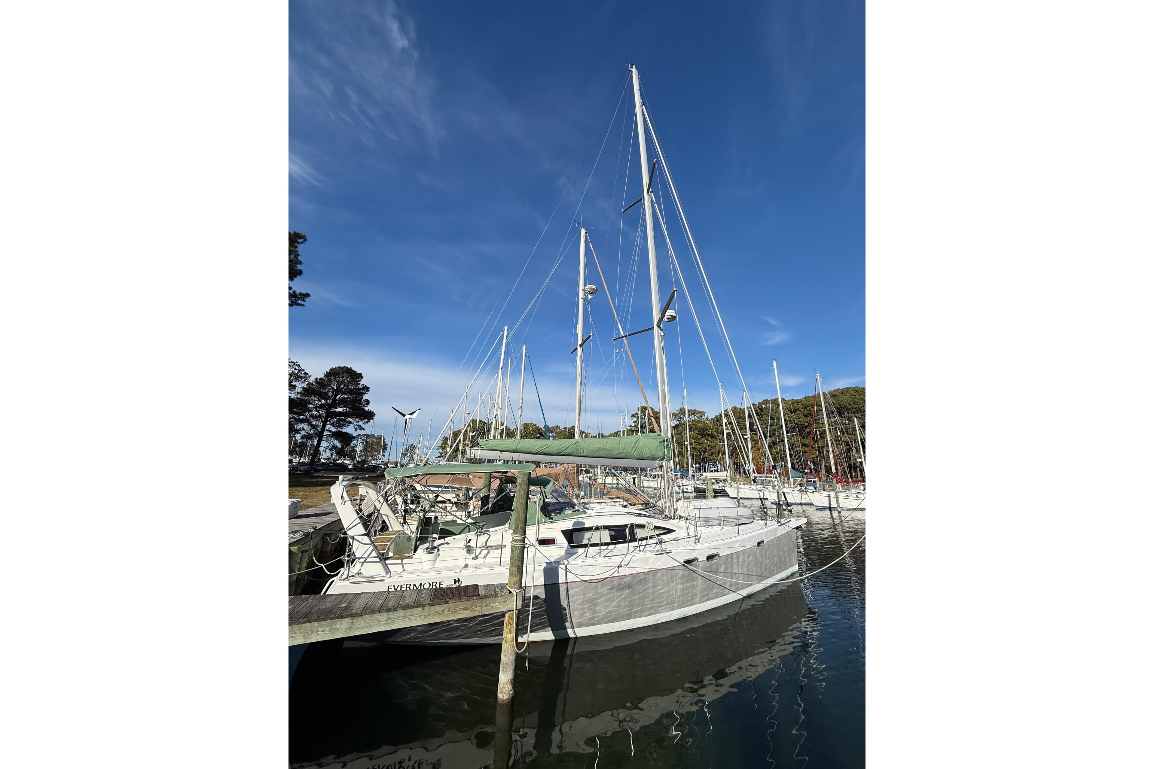 Sailboat Allures 45, 2011 model, docked in a marina under clear blue skies.