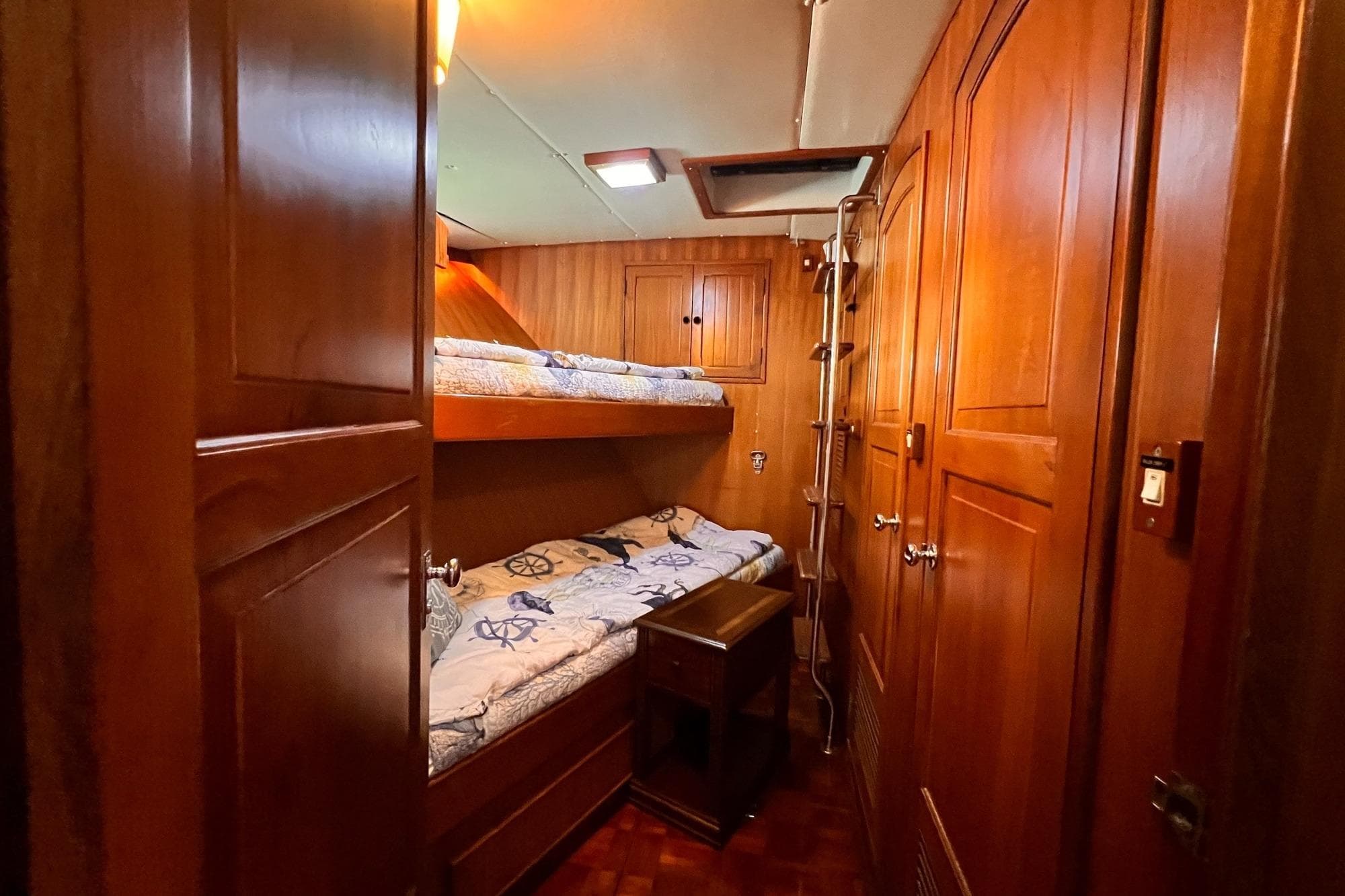 Cozy wooden cabin with bunk beds on 1985 Hartman-Palmer 60 Flush Deck Motor Yacht.