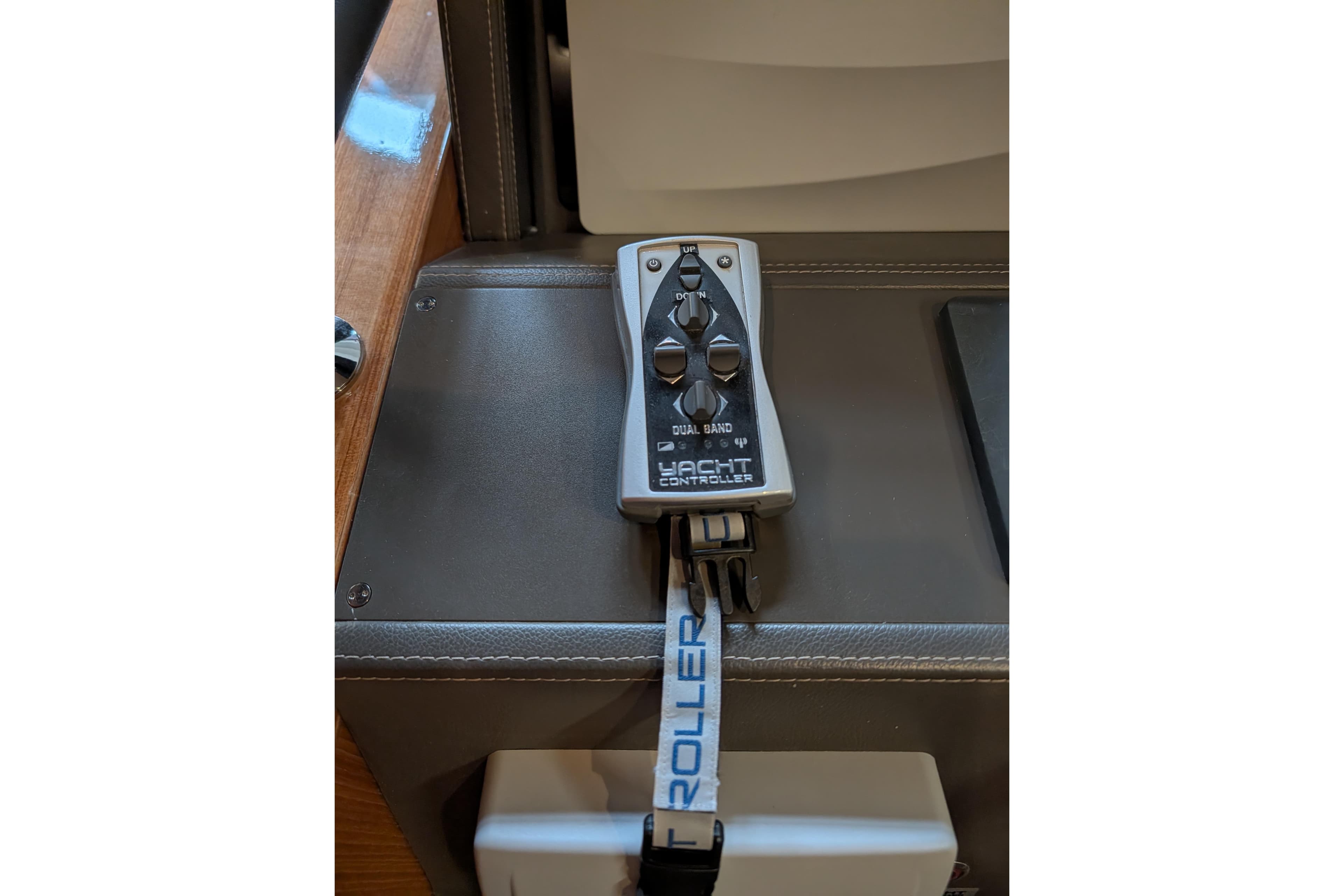 Remote control for Maritimo S58 yacht, 2015 model, on leather surface.