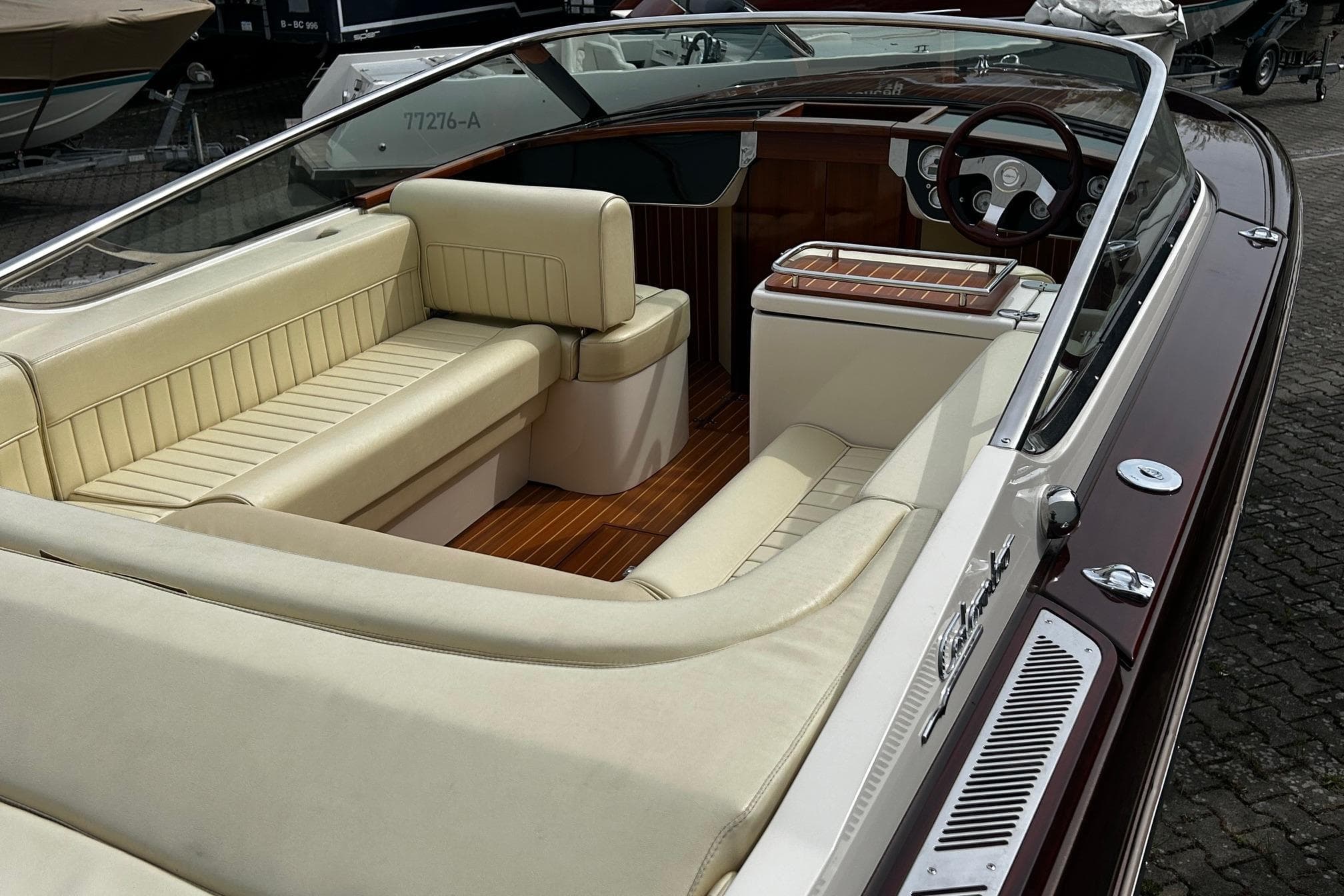 Luxurious 2014 Colombo Bellagio boat interior with cream leather seating and wooden accents.