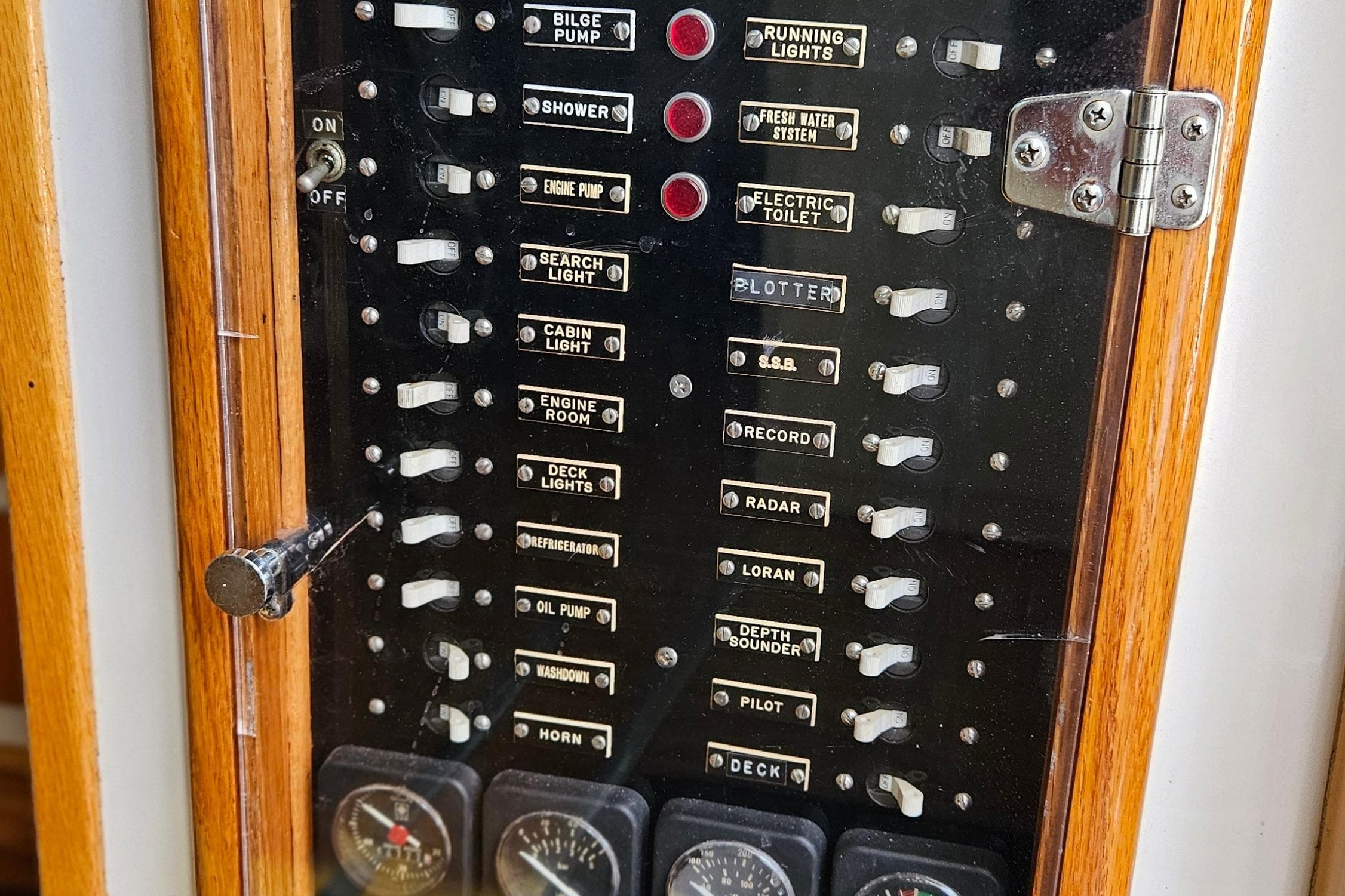 Control panel of a 1989 Breaux Brothers Sportfisherman boat with labeled switches and gauges.