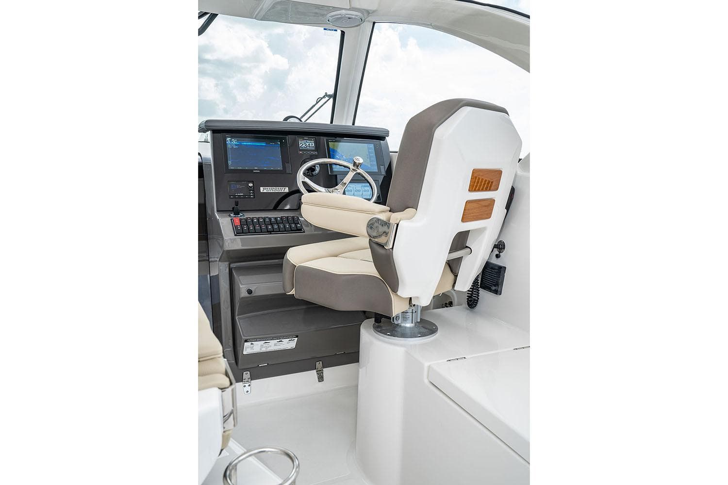 Manufacturer Provided Image: 2025 Pursuit OS 355 Offshore helm with modern controls and comfortable captain's chair.