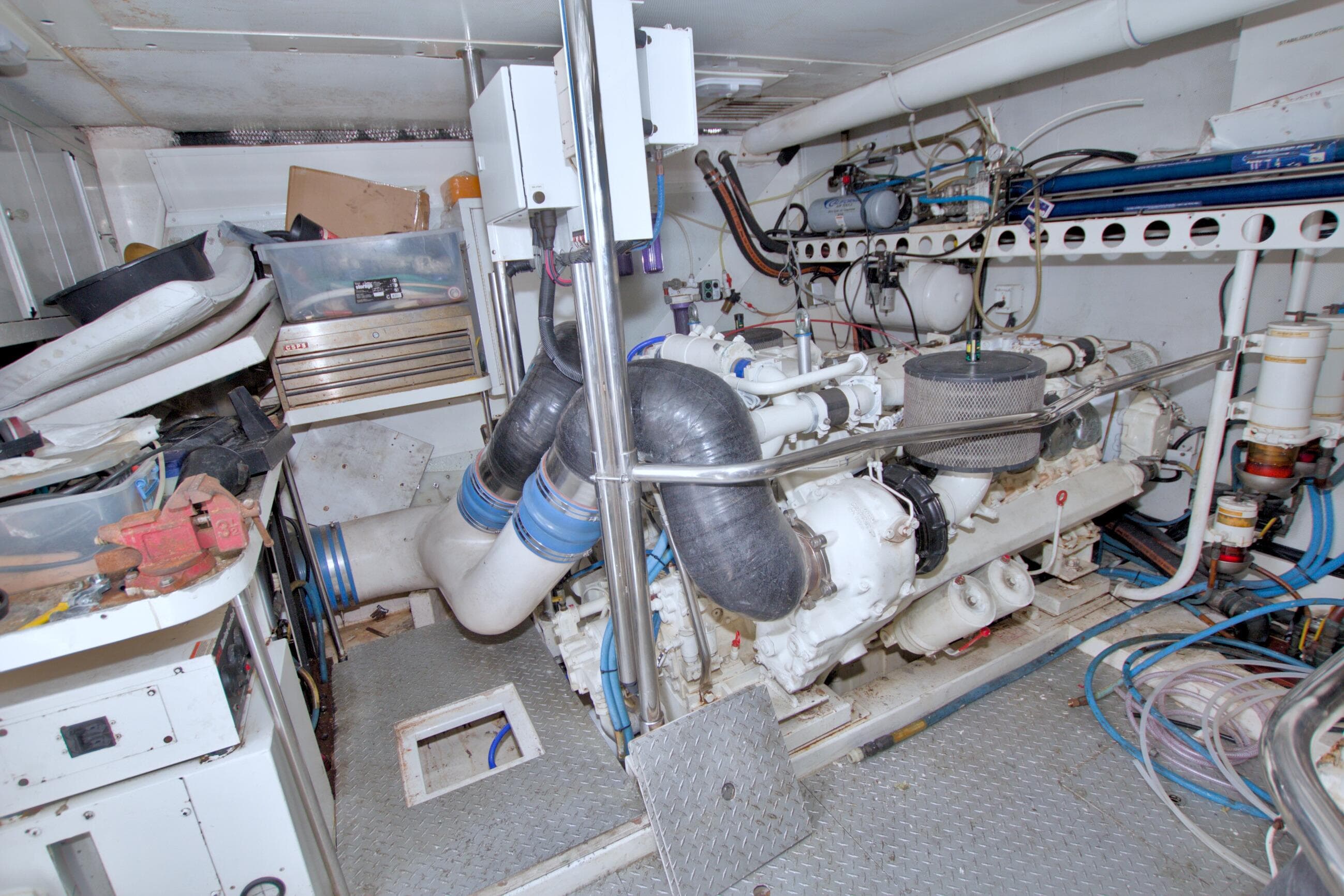 Engine room of a 1998 Lazzara 76 Skylounge Grand Salon yacht, showcasing machinery and equipment.