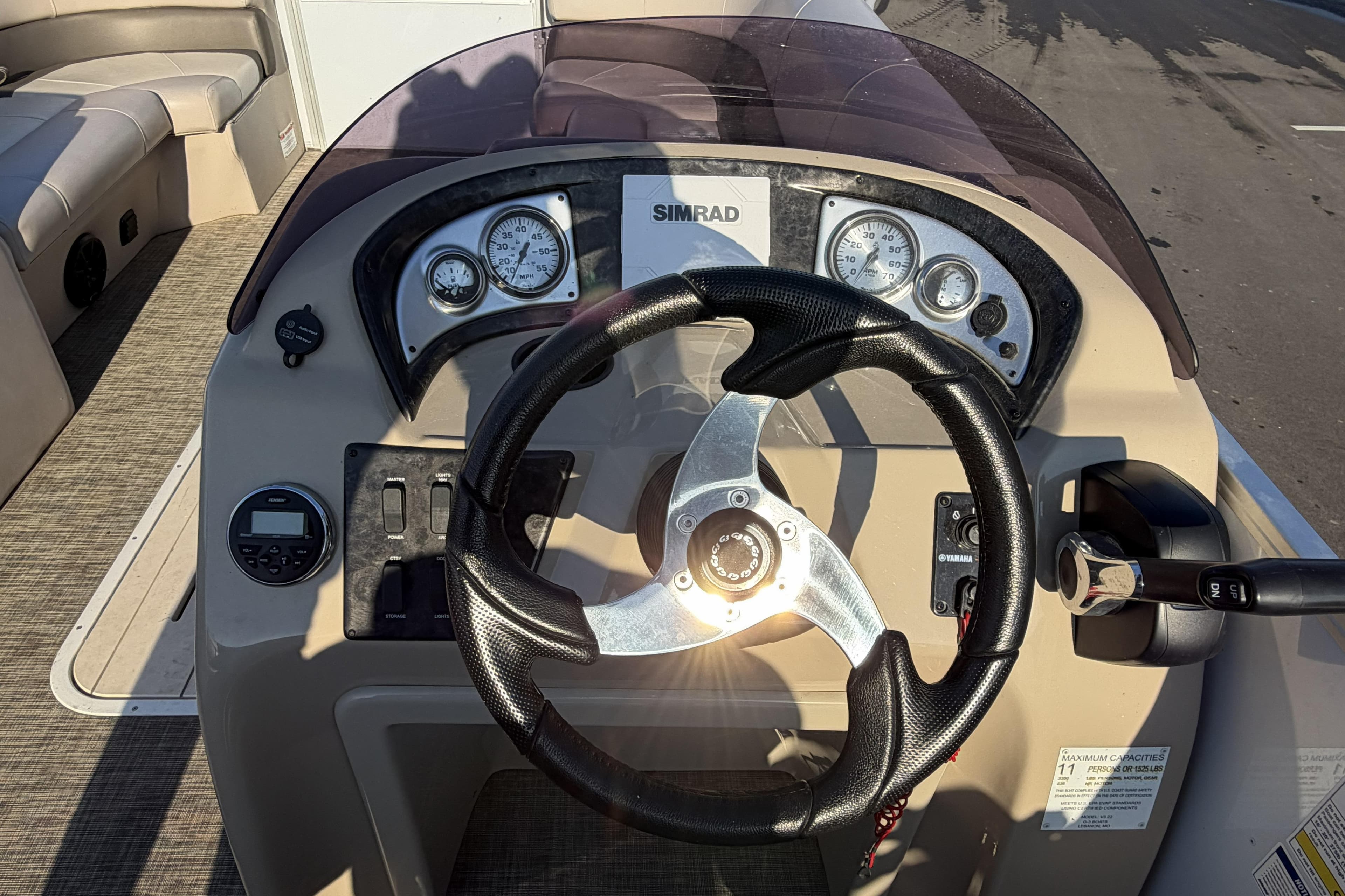 Steering console of 2019 SunCatcher V322 Cruise boat with gauges and controls.