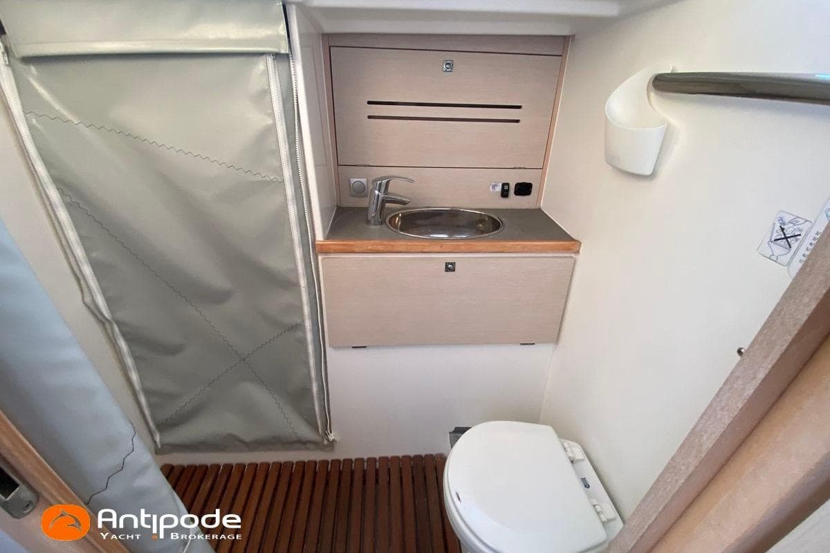 2018 JPK 45 FC yacht bathroom with sink, toilet, and wooden floor.