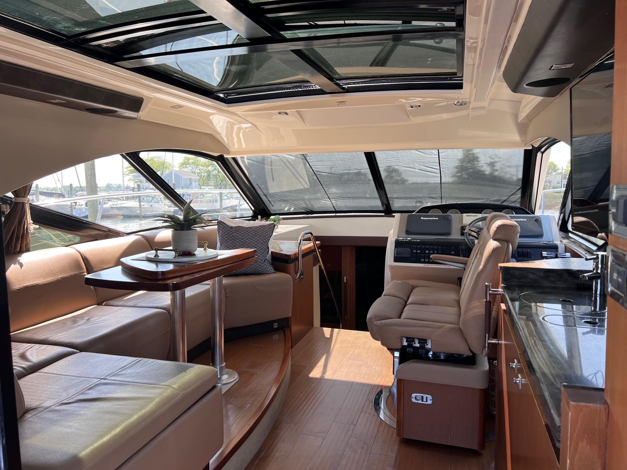 Luxurious interior of 2014 Sea Ray 510 Sundancer yacht with plush seating and modern helm.