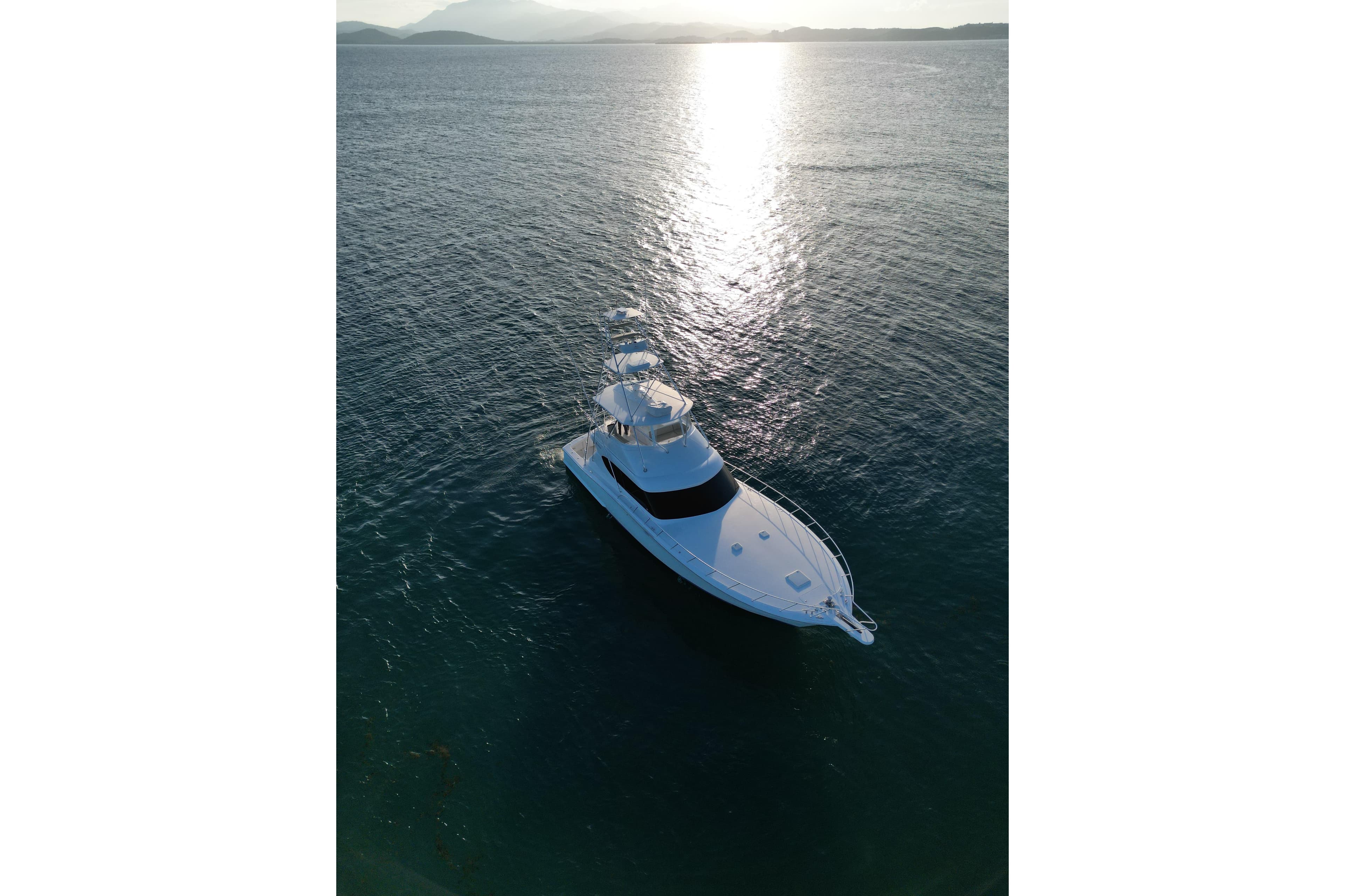 Aerial view of 2009 Hatteras 60 Convertible yacht on calm ocean waters.