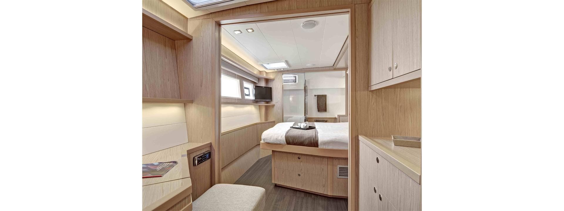 Luxurious interior of 2013 Lagoon 52 yacht cabin with modern furnishings and natural light.
