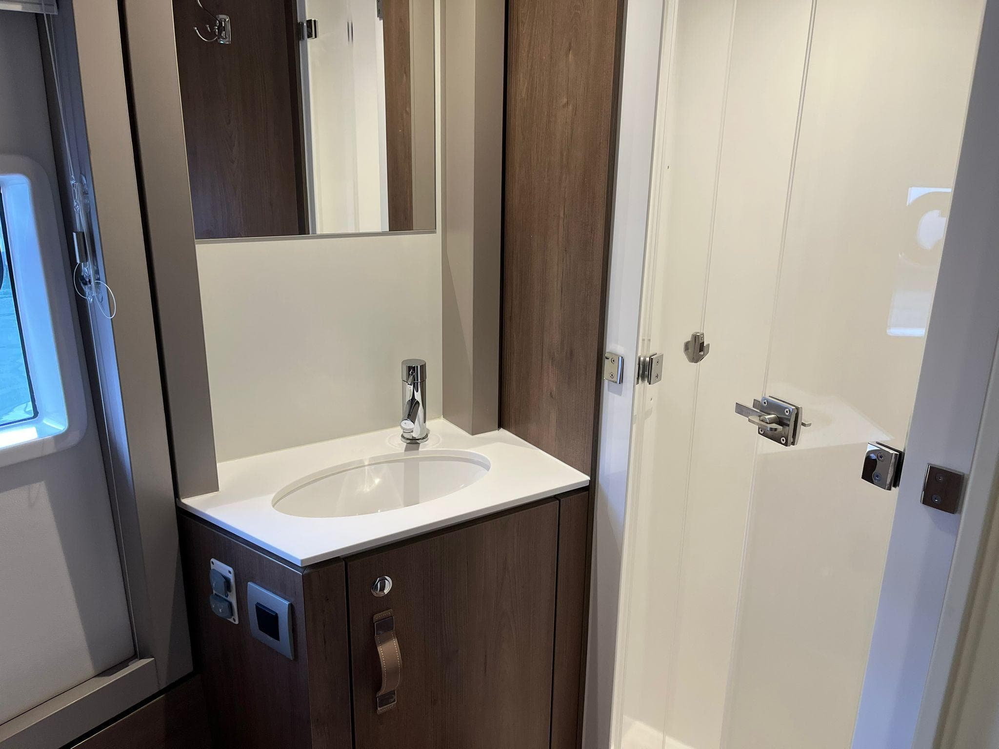 Modern bathroom in 2023 Bali 4.4 model yacht with sleek sink and shower.