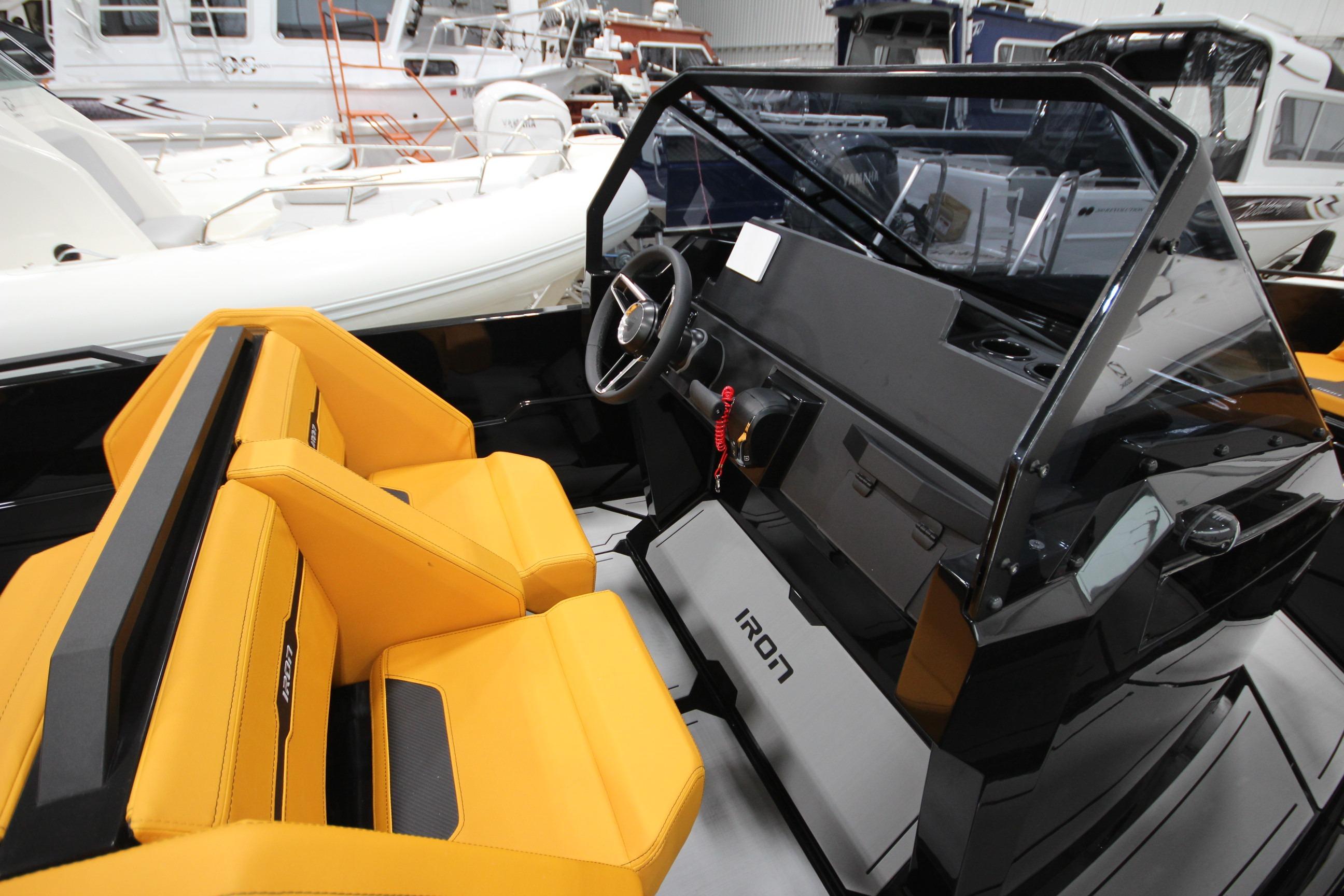 Interior of 2026 Iron 767 T-top boat with yellow seating and modern dashboard.