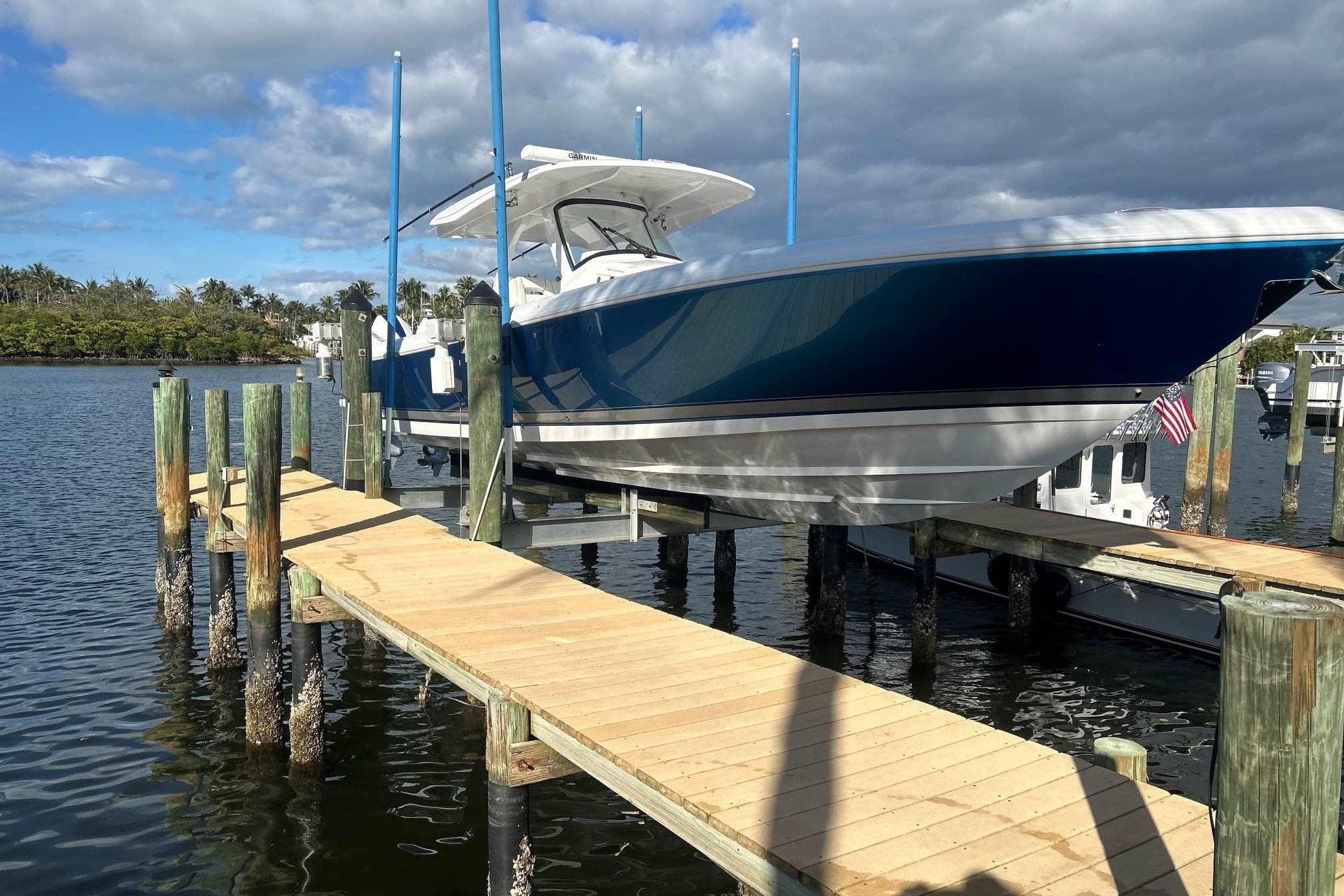 2025 Intrepid 375 Nomad SE boat docked on a sunny day with blue skies.