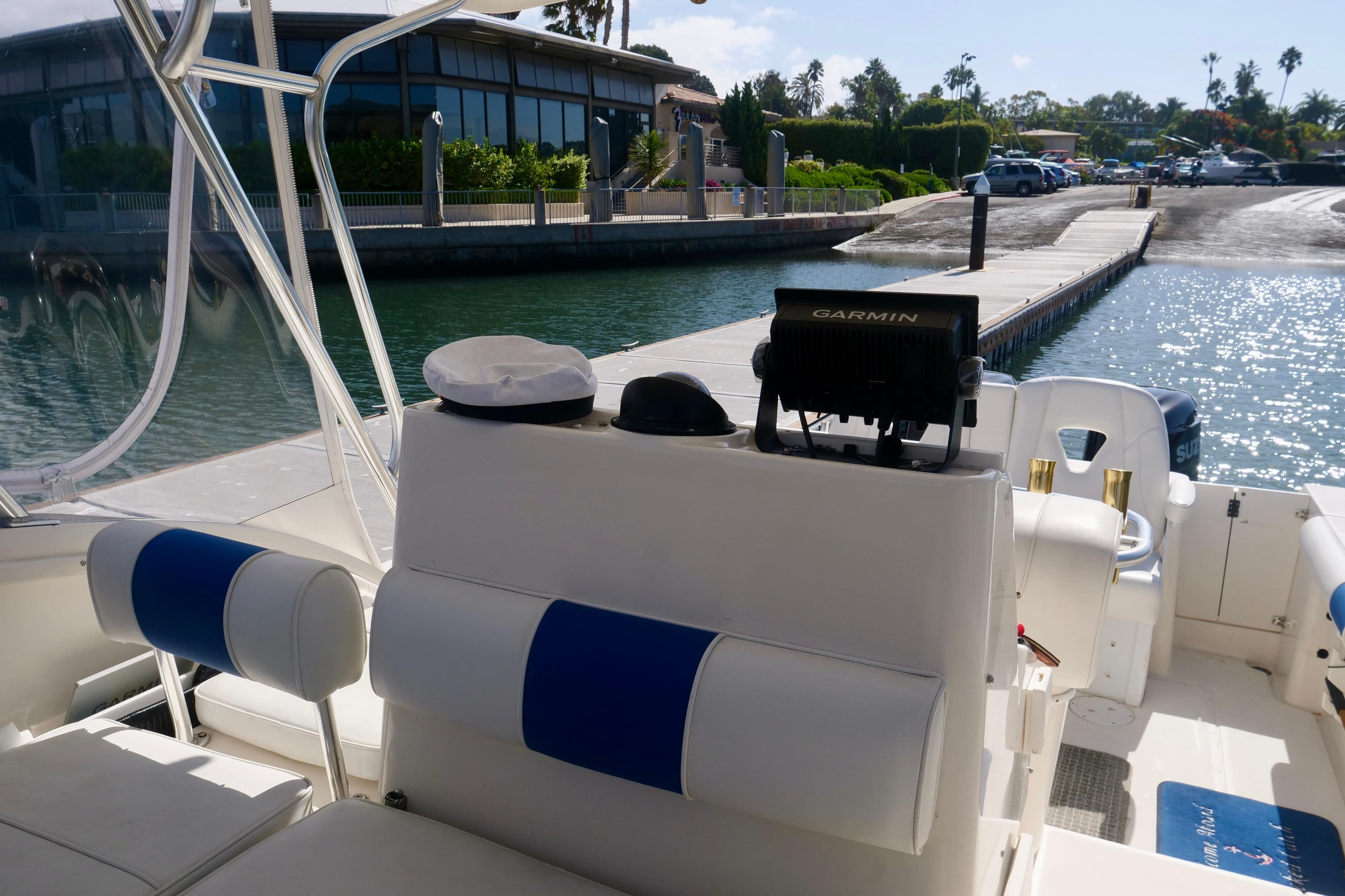 1999 Pursuit 2870 Walkaround boat interior with Garmin equipment, docked near waterfront buildings.
