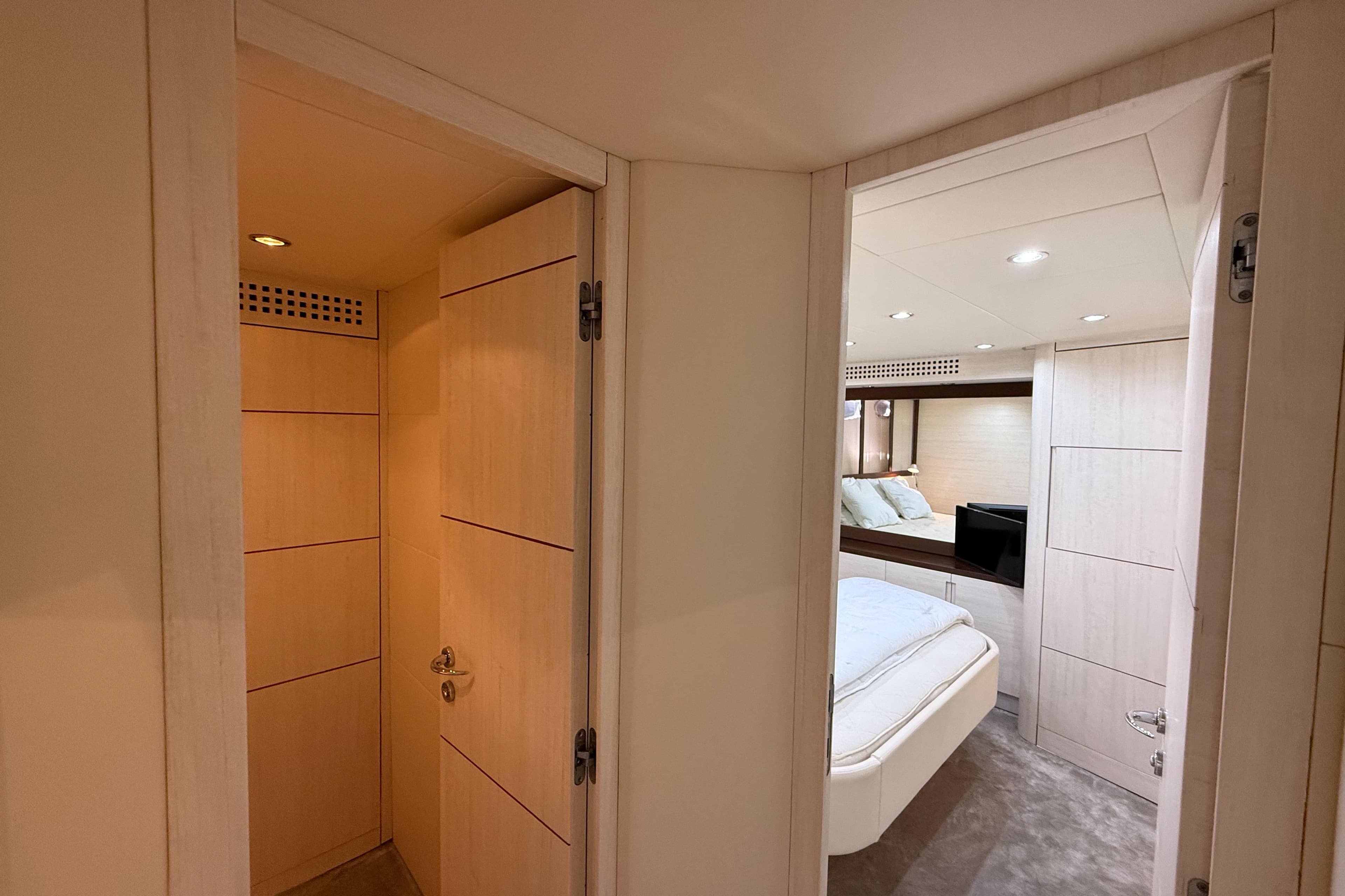 Interior of 2006 Pershing 56 yacht, featuring a cozy bedroom and modern design.