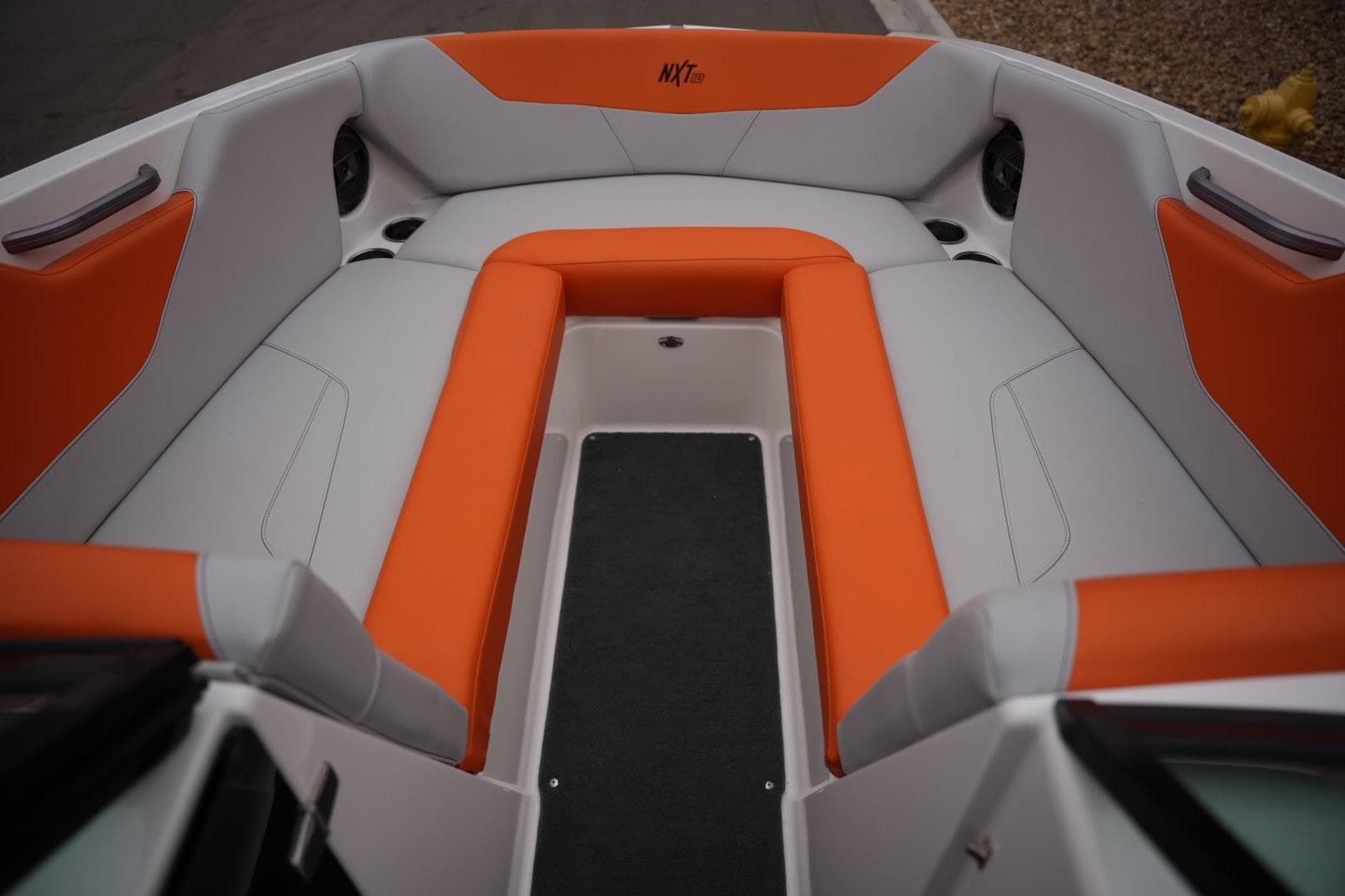 2021 MasterCraft NXT24 boat interior with orange and gray seating.