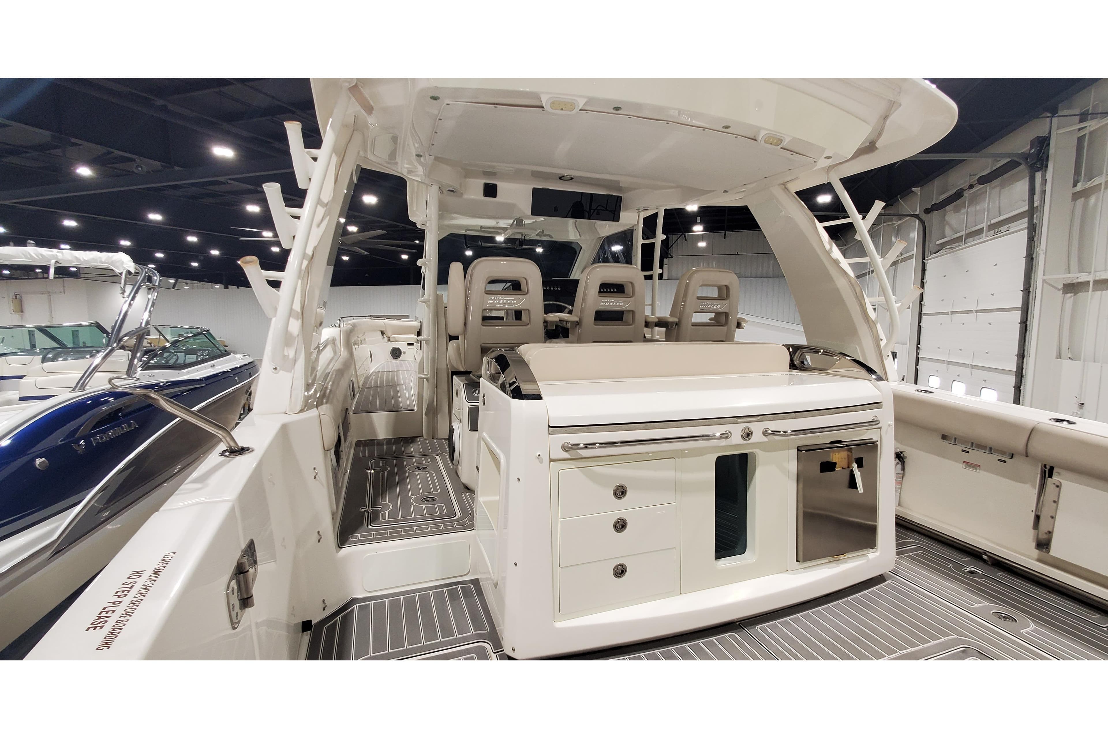 2016 Boston Whaler 420 Outrage boat interior with seating and storage, displayed indoors.