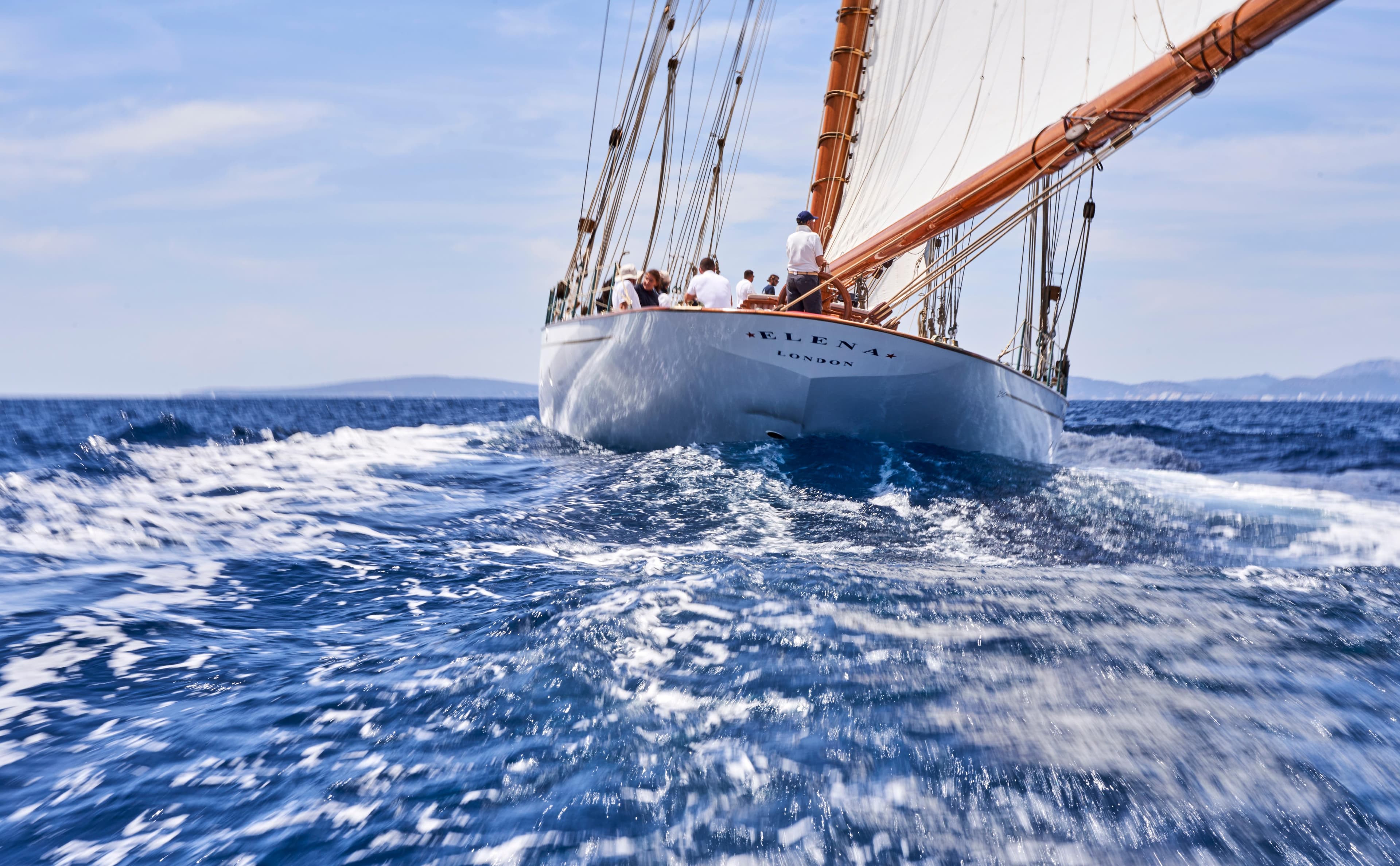 Sailing yacht on open sea, Factoria Naval de Marin Custom, 2009 model, cutting through waves.