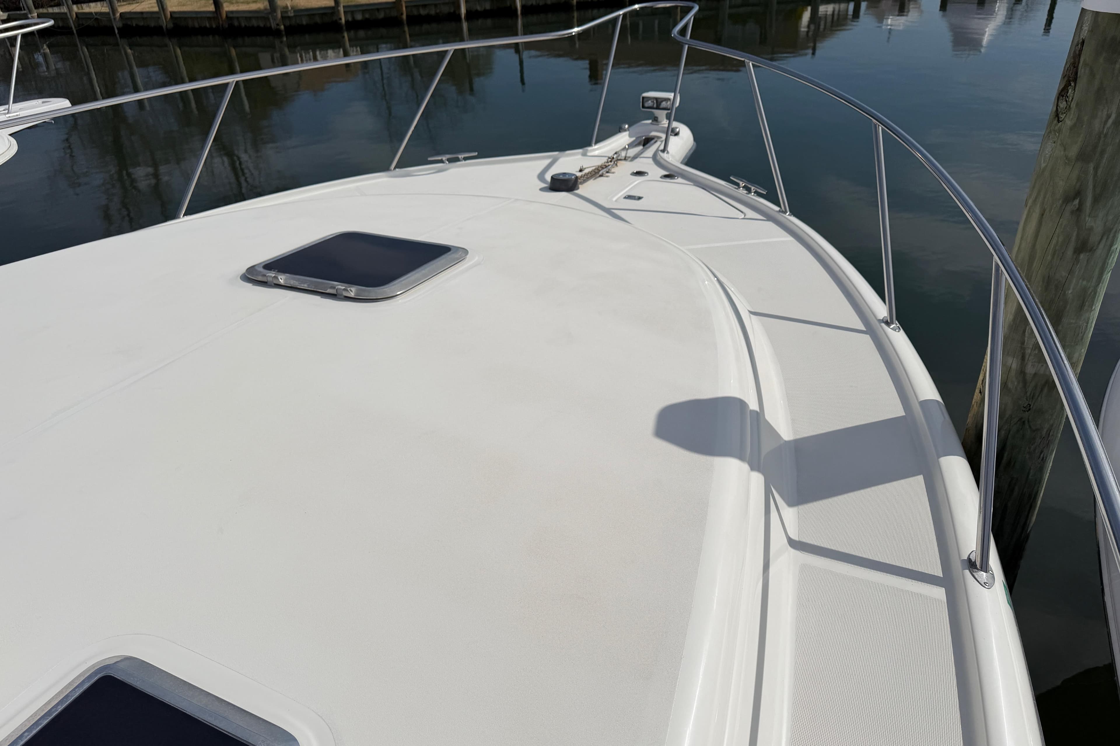Bow view of a 2004 Tiara 3800 yacht docked at a marina.