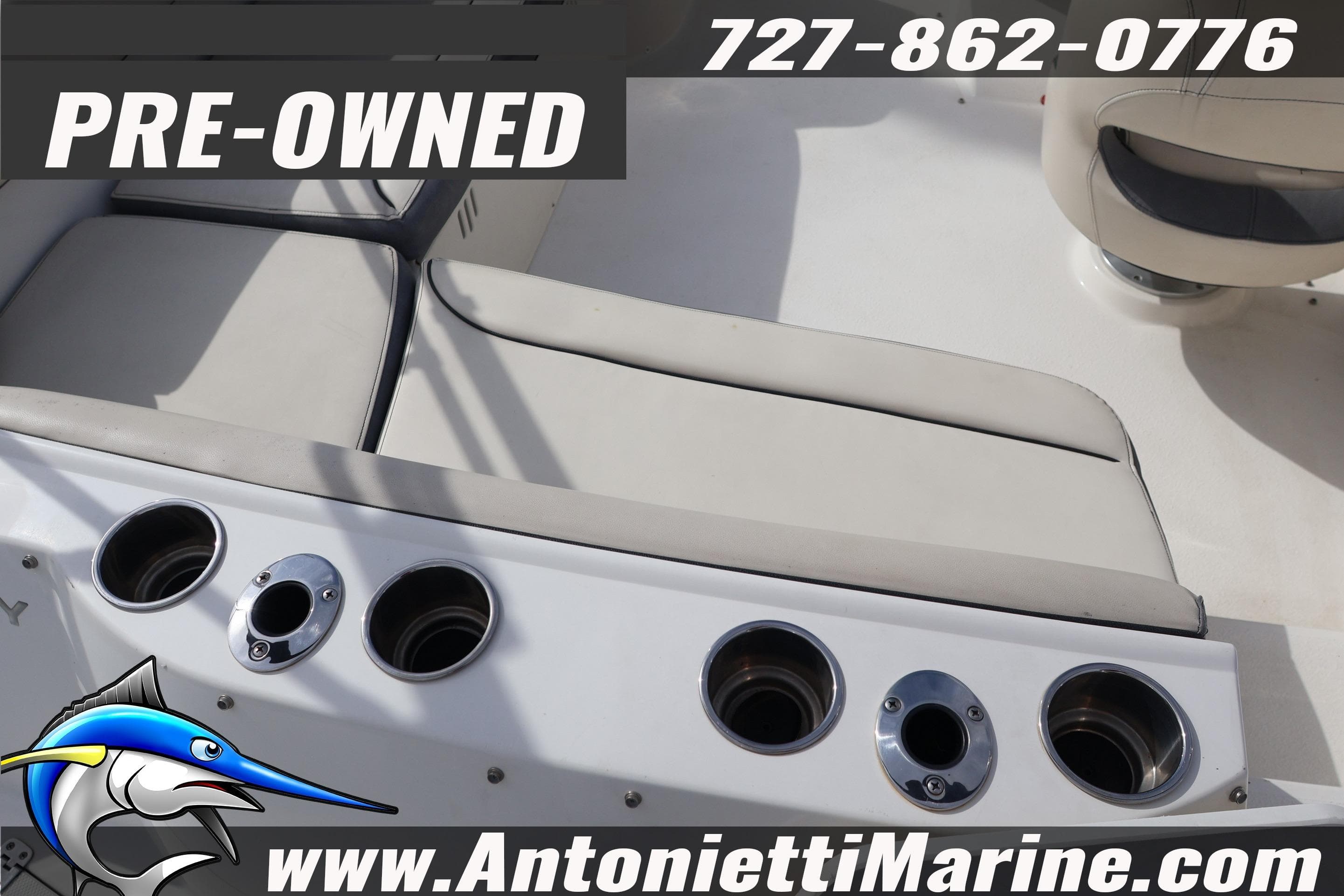 Pre-owned 2023 Stingray 212 SC boat interior with seating and cup holders.