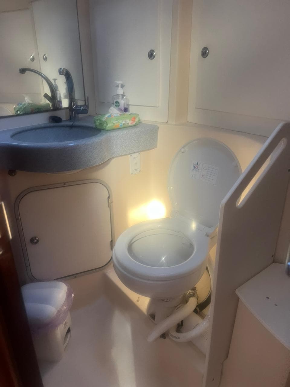 Bathroom interior of 2000 Bavaria 47 Cruiser yacht, featuring sink and toilet.