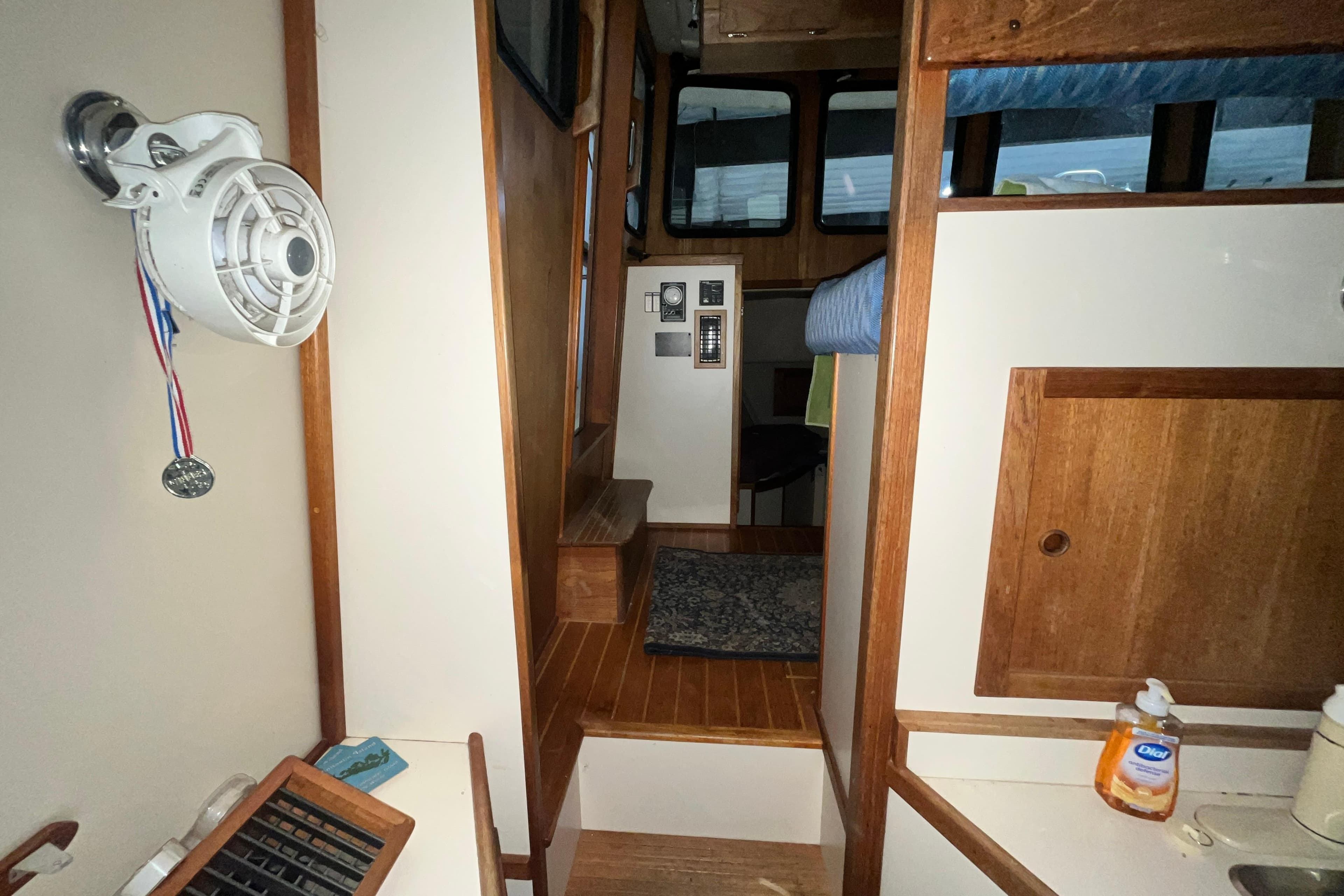 Interior of 1999 Nordic Tug 32, featuring wood paneling and compact design.