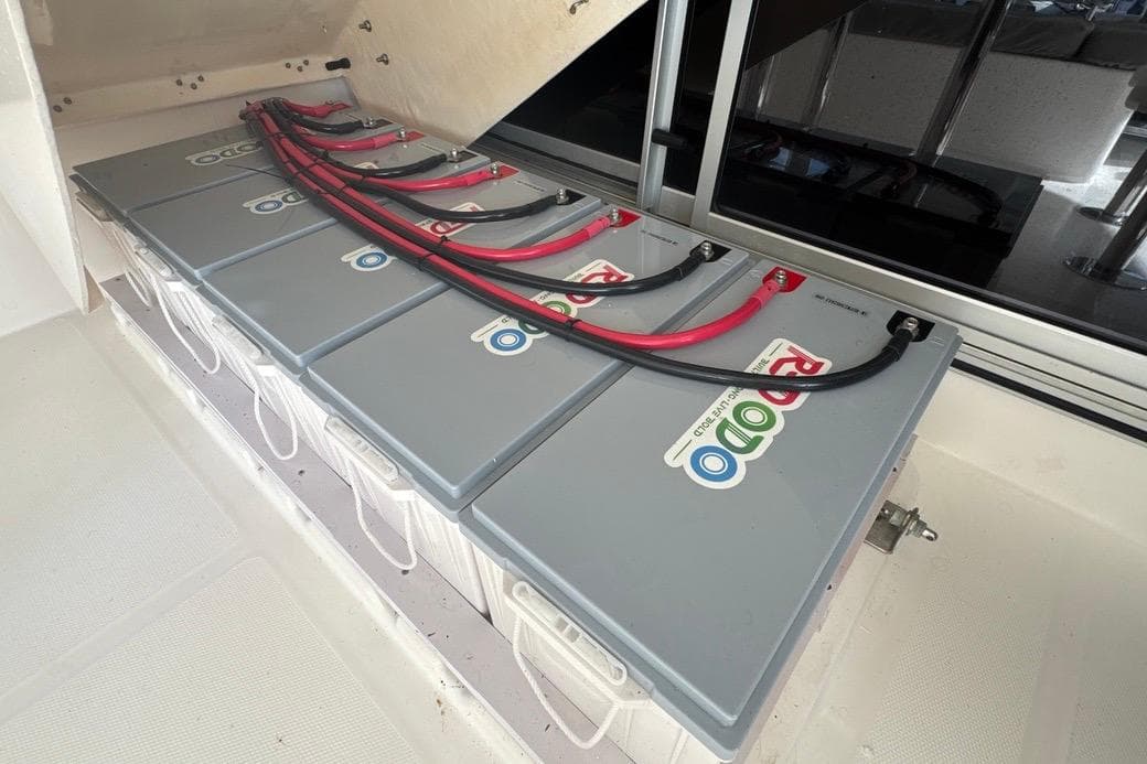 Battery compartment of a 2018 Leopard 48 yacht with connected cables.