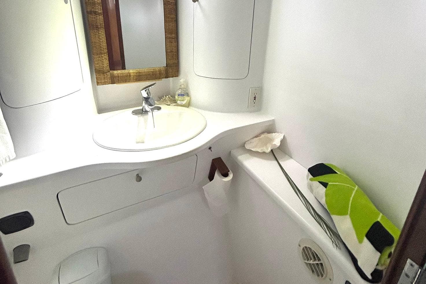 Bathroom interior of 2002 Custom 64 Stuart Catamarans with sink, mirror, and towel.