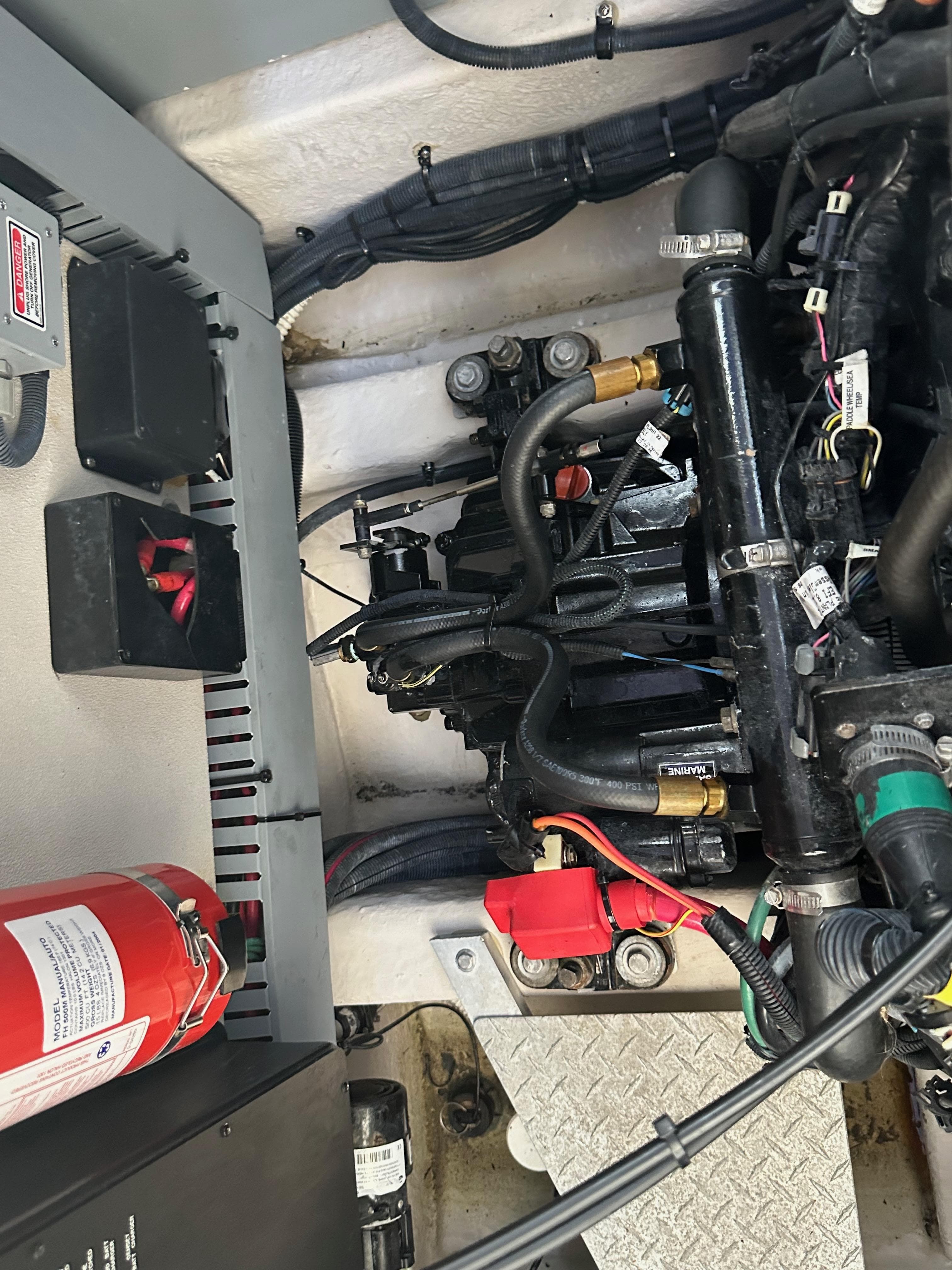Engine compartment of a 2004 Sea Ray 360 Sundancer with visible wiring and fire extinguisher.