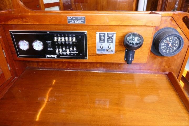 Control panel of a 1978 Tartan 37 sailboat with gauges and switches.