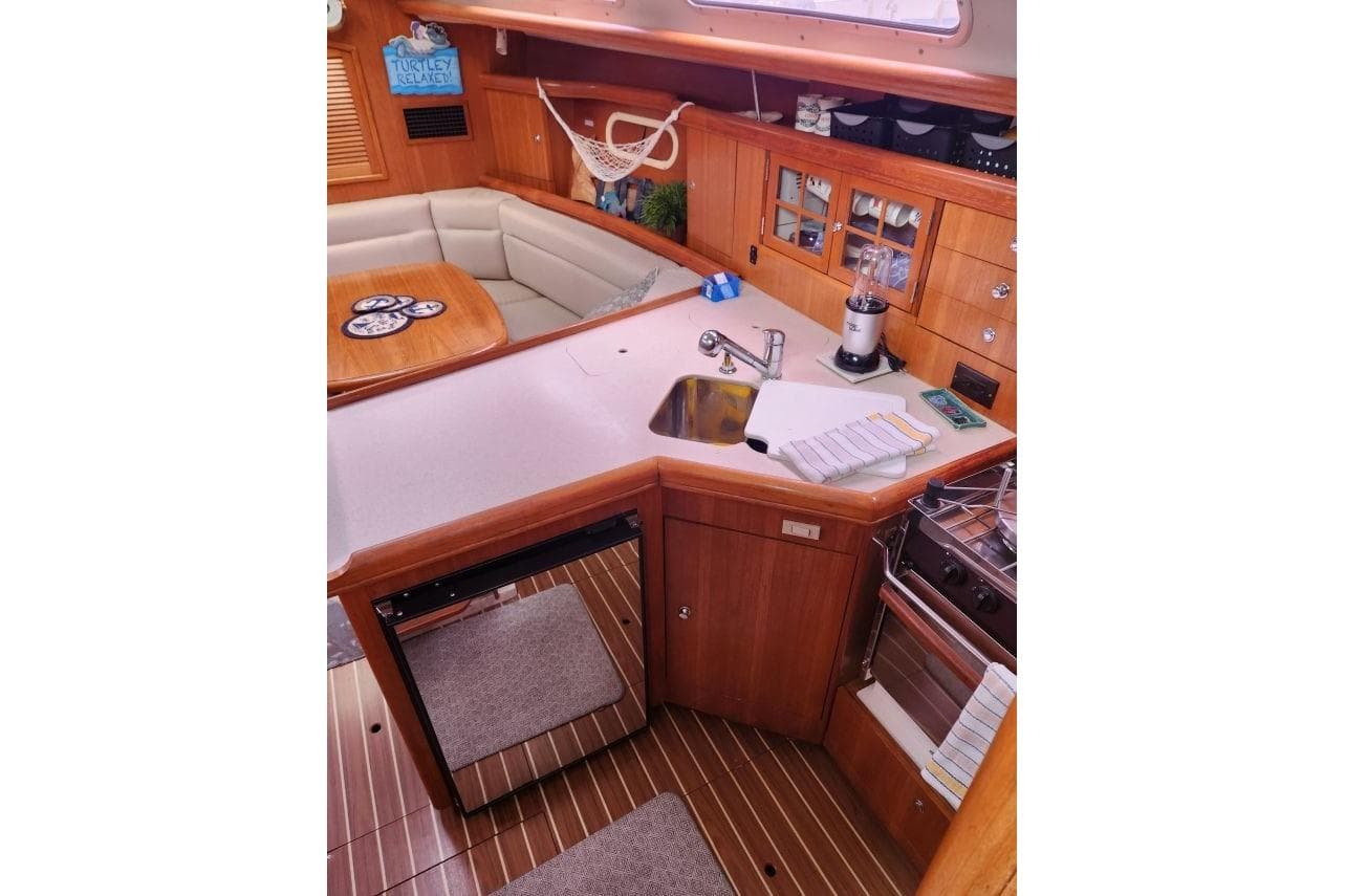 Interior of 2004 Hunter 36 sailboat with kitchen and seating area.